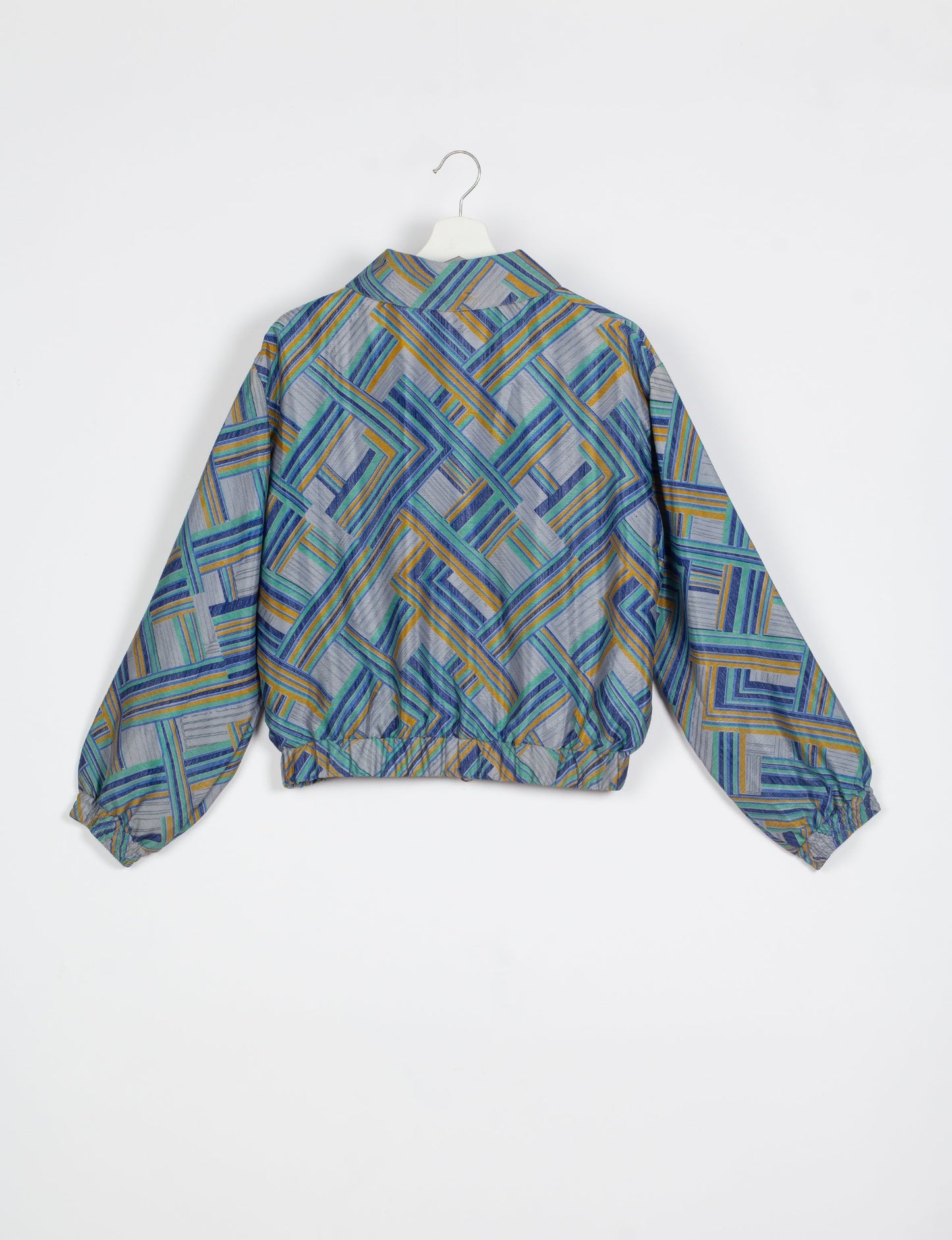 Stylish BOMBER JACKET, an upcycled clothing masterpiece with a cute cropped shape, elasticated details, and detachable metallic zipper. Contrast sari print lining adds a unique touch. Explore sustainable and eco-friendly fashion.