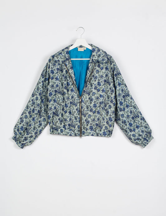 Stylish BOMBER JACKET, an upcycled clothing masterpiece with a cute cropped shape, elasticated details, and detachable metallic zipper. Contrast sari print lining adds a unique touch. Explore sustainable and eco-friendly fashion.