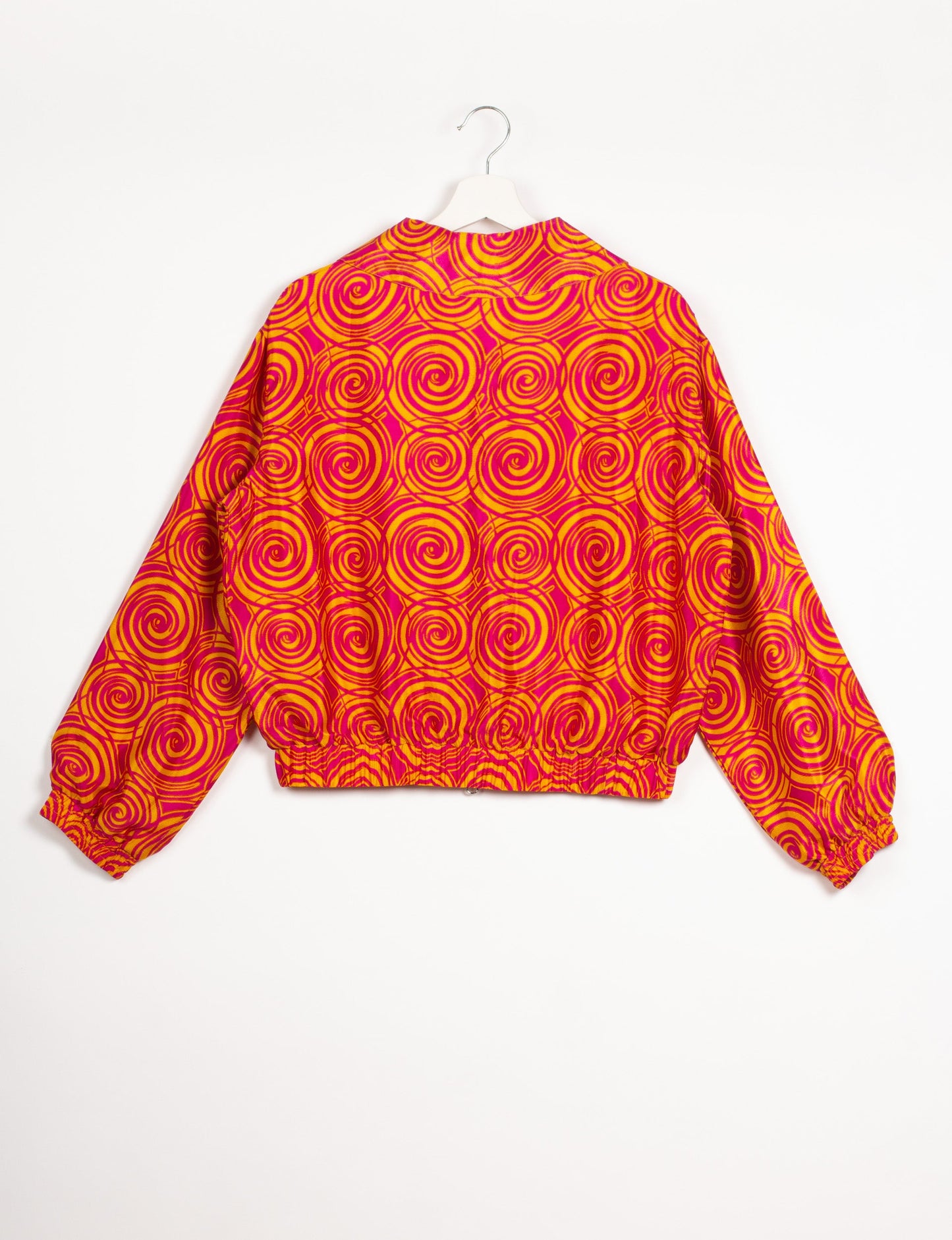 Stylish BOMBER JACKET, an upcycled clothing masterpiece with a cute cropped shape, elasticated details, and detachable metallic zipper. Contrast sari print lining adds a unique touch. Explore sustainable and eco-friendly fashion.