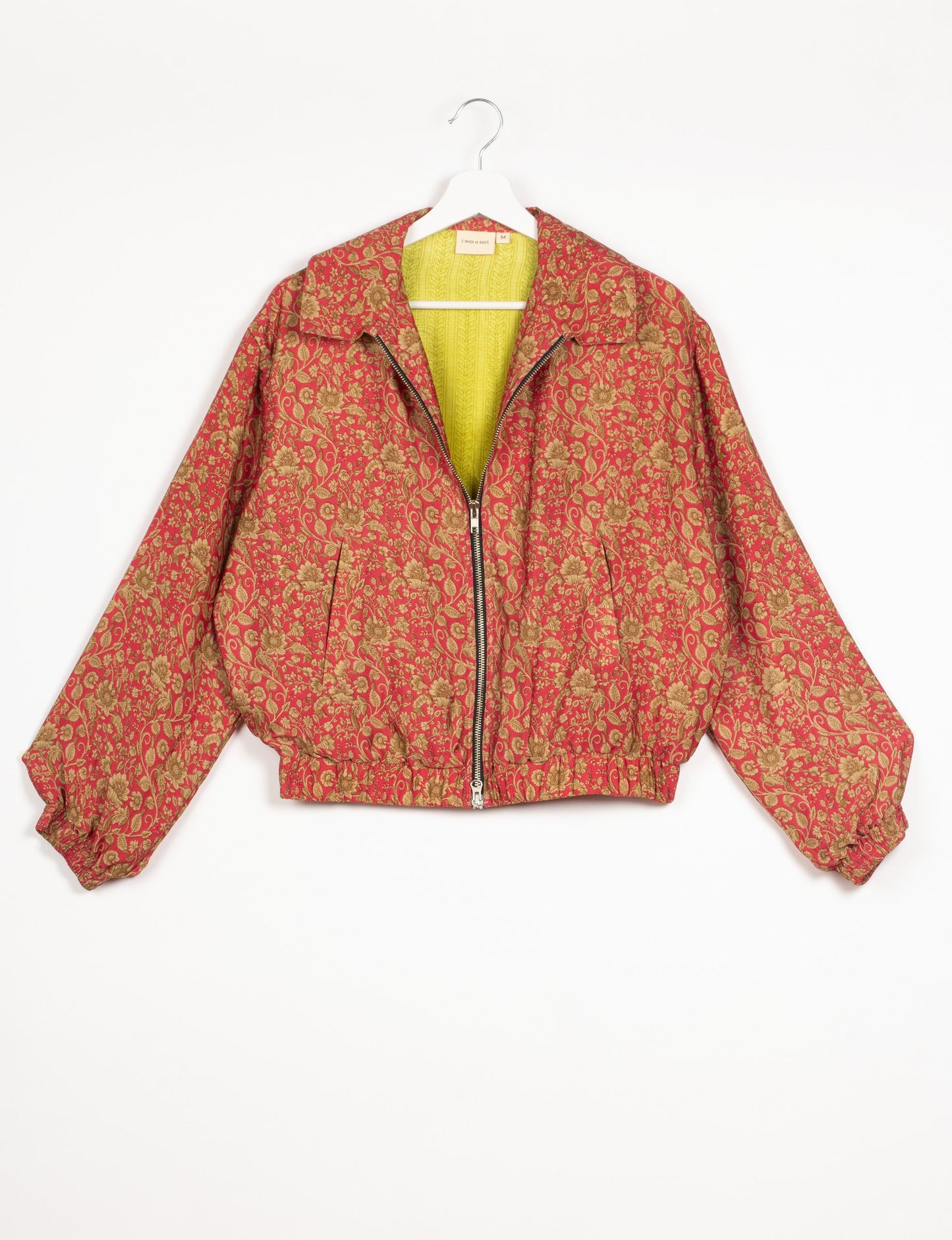 Stylish BOMBER JACKET, an upcycled clothing masterpiece with a cute cropped shape, elasticated details, and detachable metallic zipper. Contrast sari print lining adds a unique touch. Explore sustainable and eco-friendly fashion.