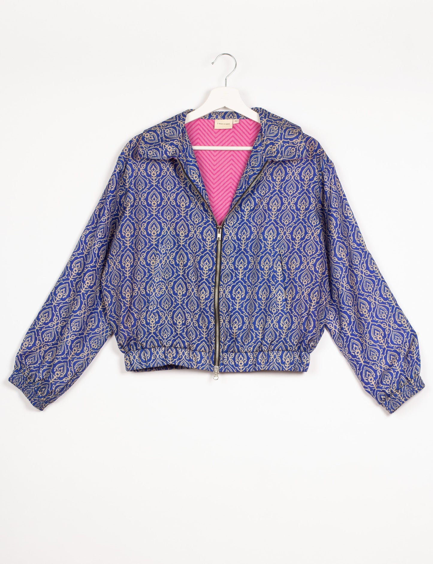 Stylish BOMBER JACKET, an upcycled clothing masterpiece with a cute cropped shape, elasticated details, and detachable metallic zipper. Contrast sari print lining adds a unique touch. Explore sustainable and eco-friendly fashion.