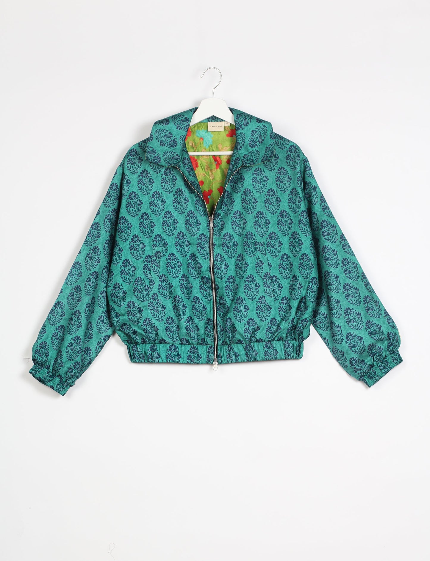 Stylish BOMBER JACKET, an upcycled clothing masterpiece with a cute cropped shape, elasticated details, and detachable metallic zipper. Contrast sari print lining adds a unique touch. Explore sustainable and eco-friendly fashion.