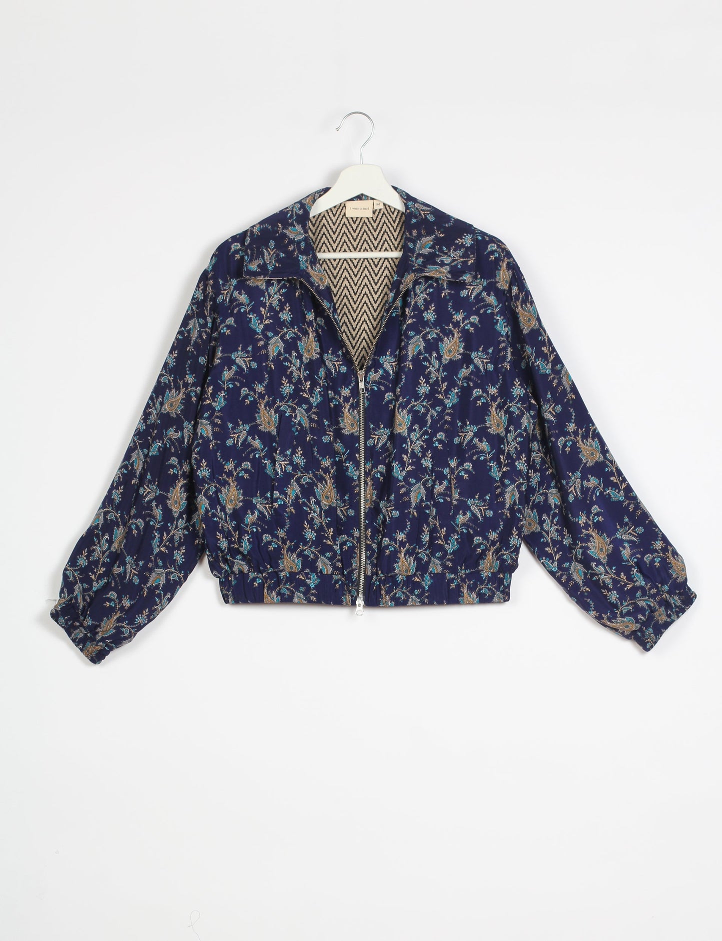 Stylish BOMBER JACKET, an upcycled clothing masterpiece with a cute cropped shape, elasticated details, and detachable metallic zipper. Contrast sari print lining adds a unique touch. Explore sustainable and eco-friendly fashion.