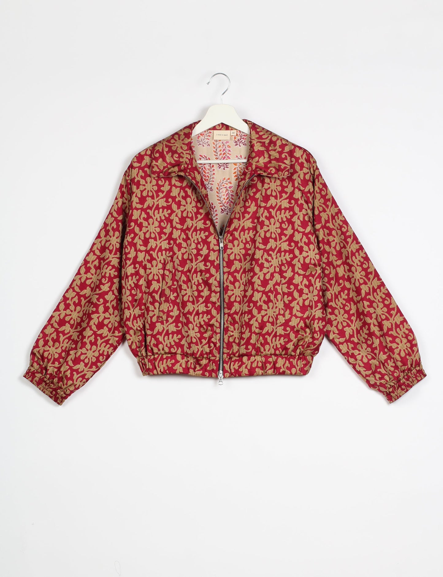 Stylish BOMBER JACKET, an upcycled clothing masterpiece with a cute cropped shape, elasticated details, and detachable metallic zipper. Contrast sari print lining adds a unique touch. Explore sustainable and eco-friendly fashion.