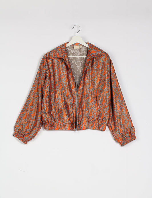 Stylish BOMBER JACKET, an upcycled clothing masterpiece with a cute cropped shape, elasticated details, and detachable metallic zipper. Contrast sari print lining adds a unique touch. Explore sustainable and eco-friendly fashion.