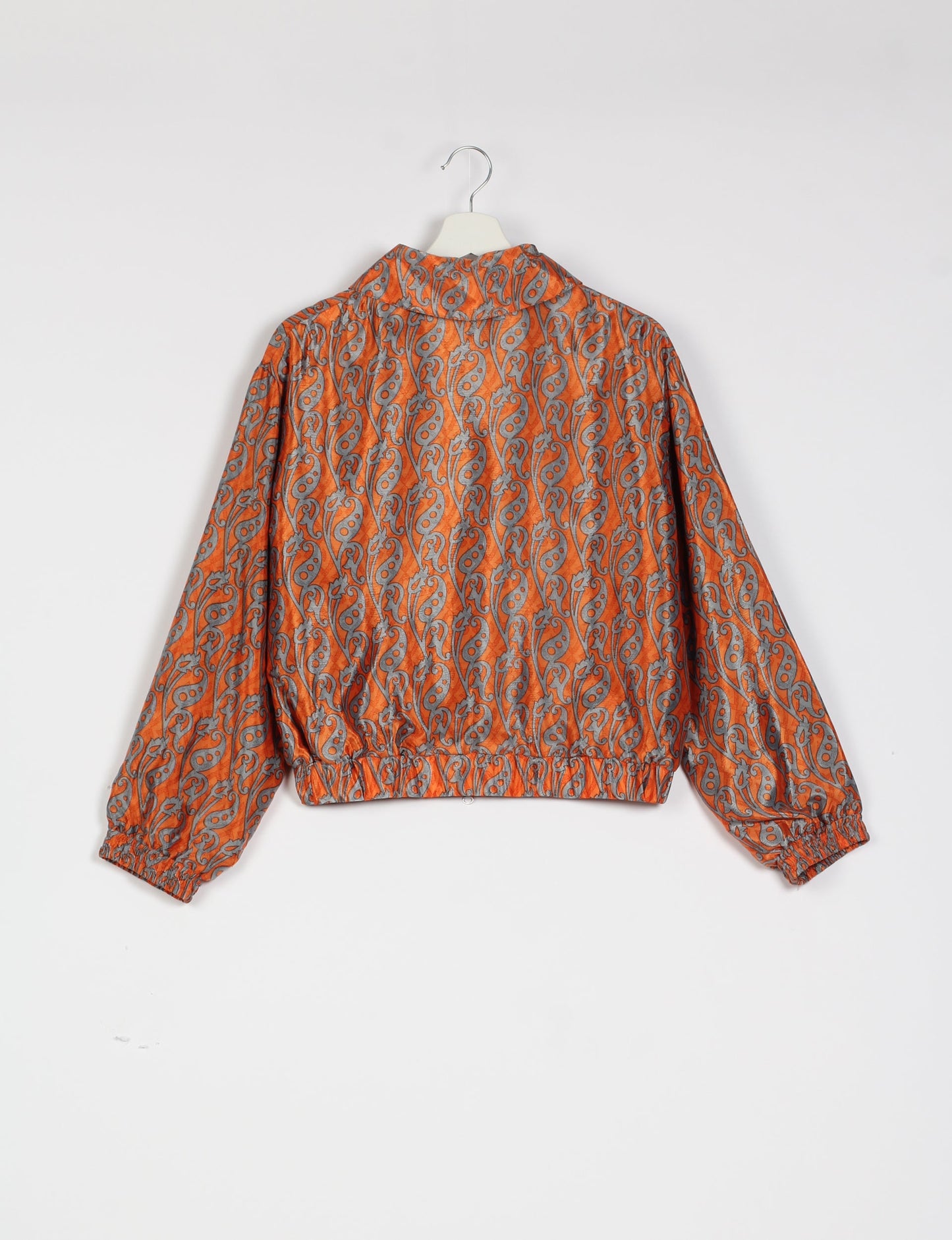 Stylish BOMBER JACKET, an upcycled clothing masterpiece with a cute cropped shape, elasticated details, and detachable metallic zipper. Contrast sari print lining adds a unique touch. Explore sustainable and eco-friendly fashion.