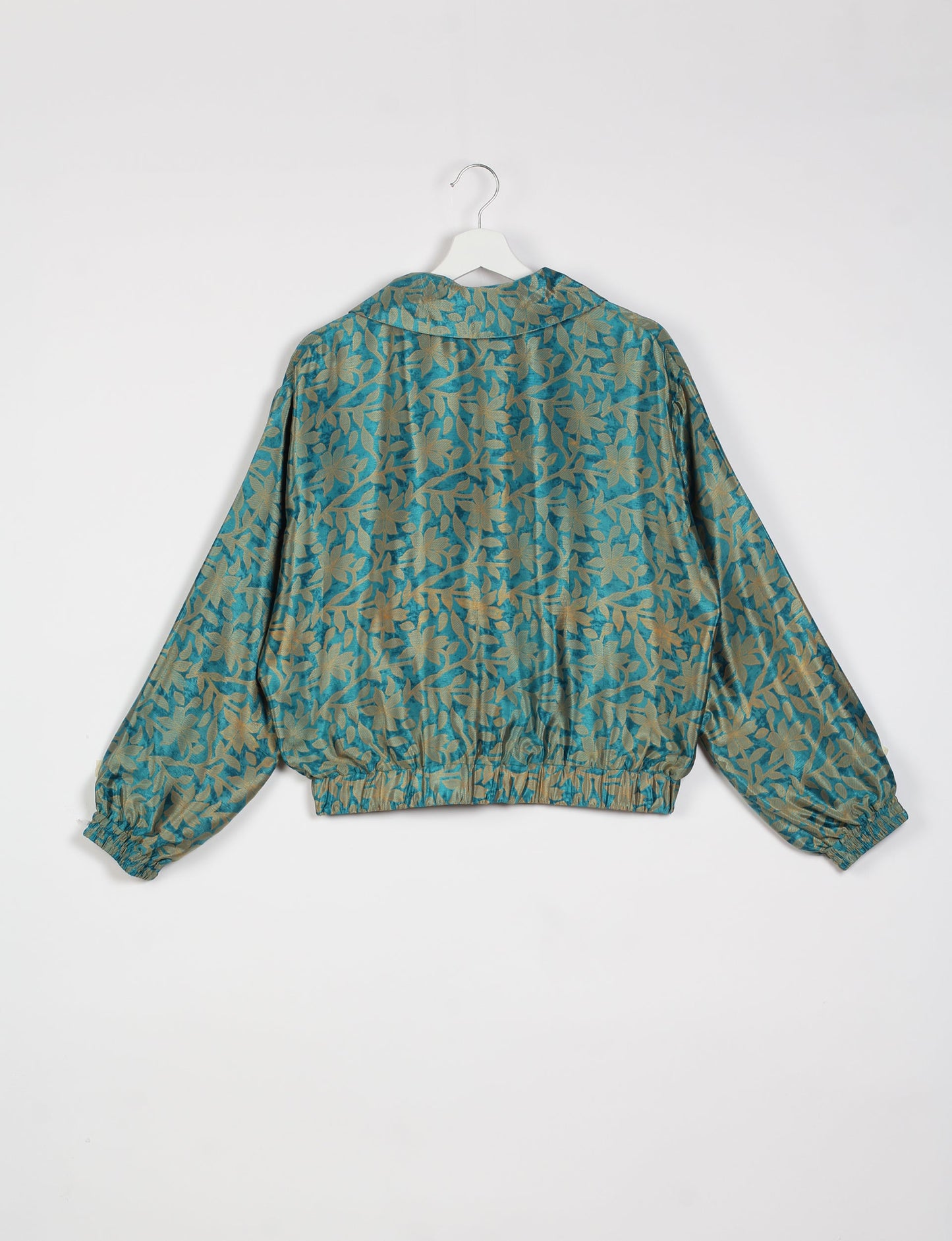 Stylish BOMBER JACKET, an upcycled clothing masterpiece with a cute cropped shape, elasticated details, and detachable metallic zipper. Contrast sari print lining adds a unique touch. Explore sustainable and eco-friendly fashion.