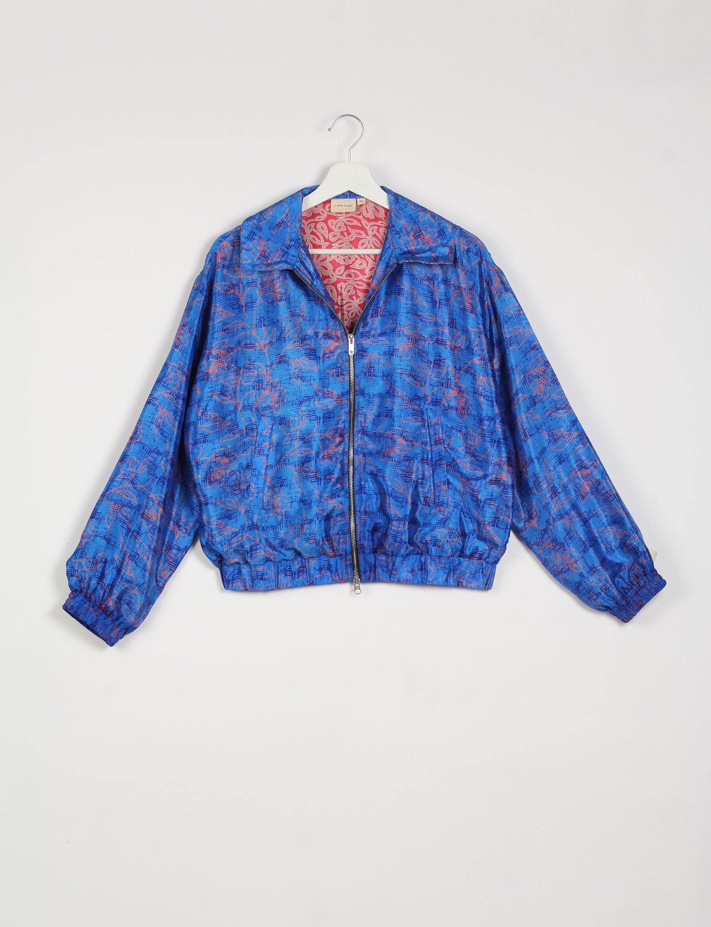 Stylish BOMBER JACKET, an upcycled clothing masterpiece with a cute cropped shape, elasticated details, and detachable metallic zipper. Contrast sari print lining adds a unique touch. Explore sustainable and eco-friendly fashion.