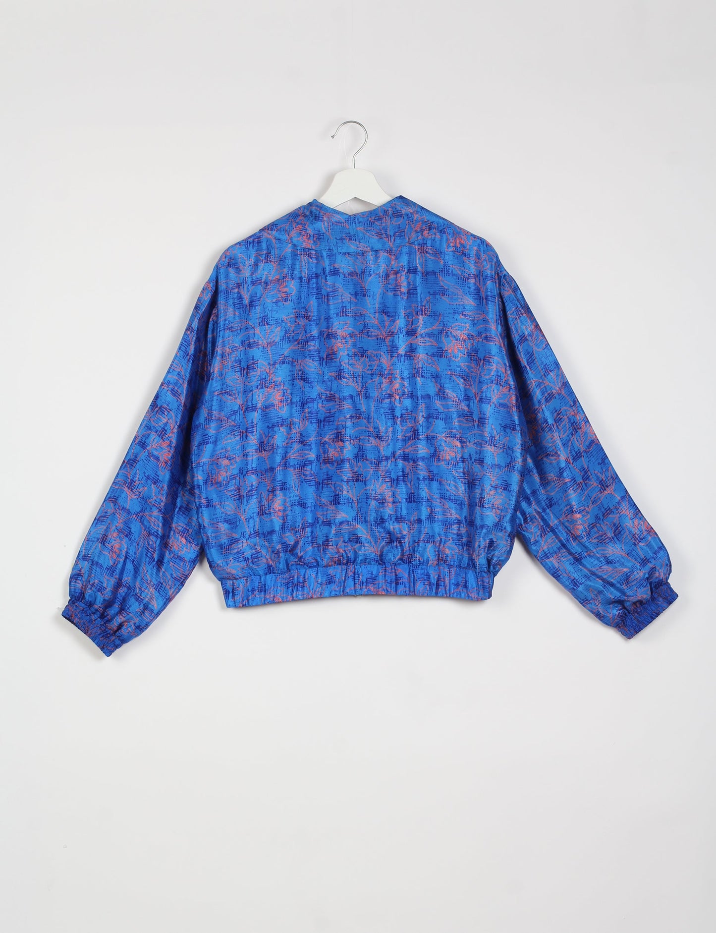 Stylish BOMBER JACKET, an upcycled clothing masterpiece with a cute cropped shape, elasticated details, and detachable metallic zipper. Contrast sari print lining adds a unique touch. Explore sustainable and eco-friendly fashion.