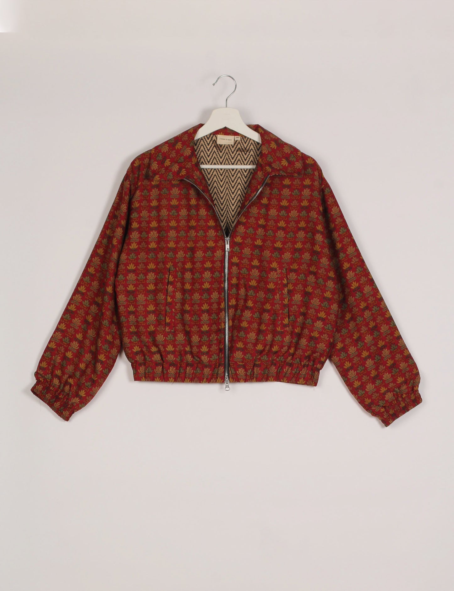 Stylish BOMBER JACKET, an upcycled clothing masterpiece with a cute cropped shape, elasticated details, and detachable metallic zipper. Contrast sari print lining adds a unique touch. Explore sustainable and eco-friendly fashion.