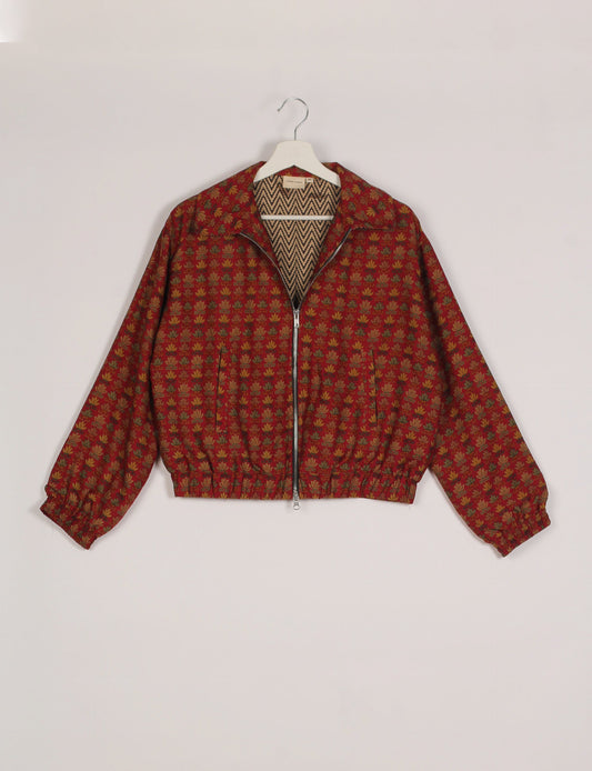 Stylish BOMBER JACKET, an upcycled clothing masterpiece with a cute cropped shape, elasticated details, and detachable metallic zipper. Contrast sari print lining adds a unique touch. Explore sustainable and eco-friendly fashion.