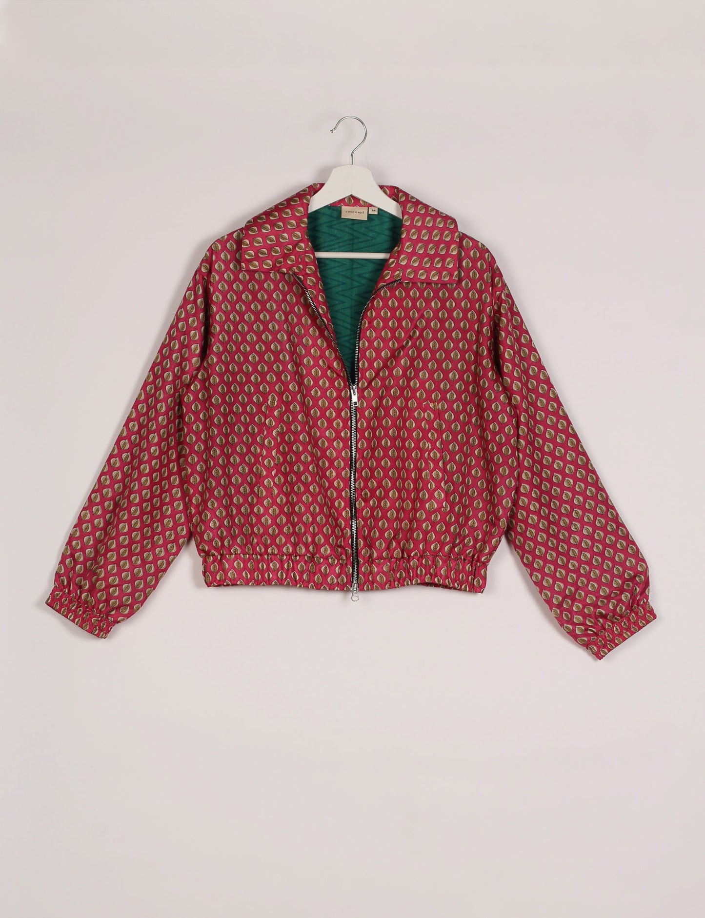 Stylish BOMBER JACKET, an upcycled clothing masterpiece with a cute cropped shape, elasticated details, and detachable metallic zipper. Contrast sari print lining adds a unique touch. Explore sustainable and eco-friendly fashion.