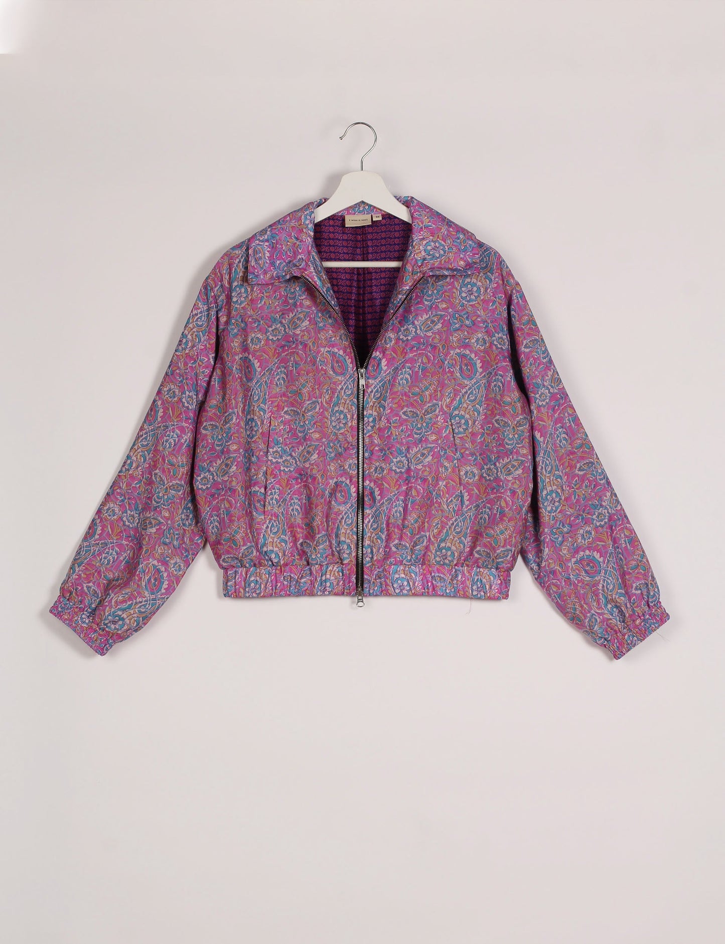 Stylish BOMBER JACKET, an upcycled clothing masterpiece with a cute cropped shape, elasticated details, and detachable metallic zipper. Contrast sari print lining adds a unique touch. Explore sustainable and eco-friendly fashion.