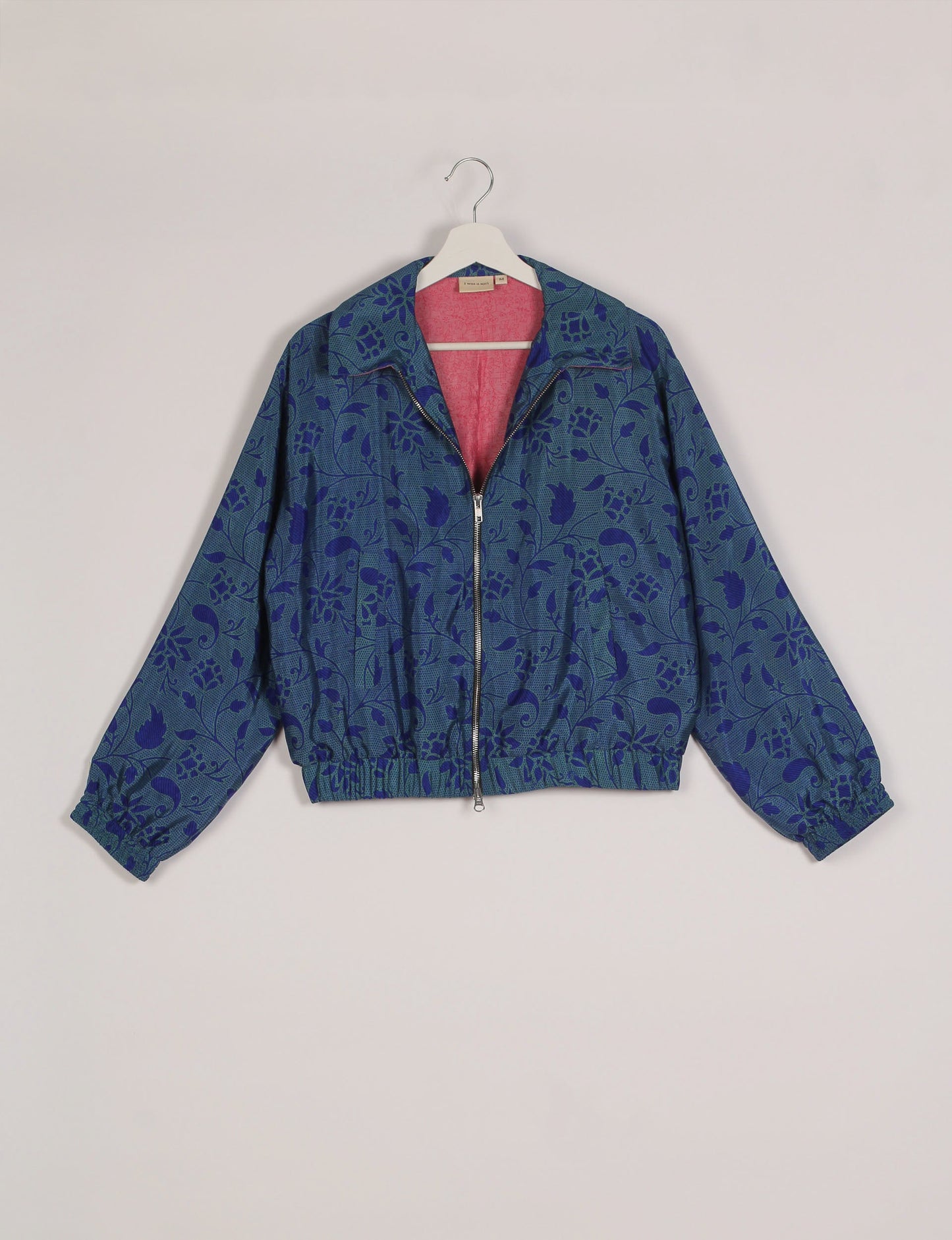 Stylish BOMBER JACKET, an upcycled clothing masterpiece with a cute cropped shape, elasticated details, and detachable metallic zipper. Contrast sari print lining adds a unique touch. Explore sustainable and eco-friendly fashion.