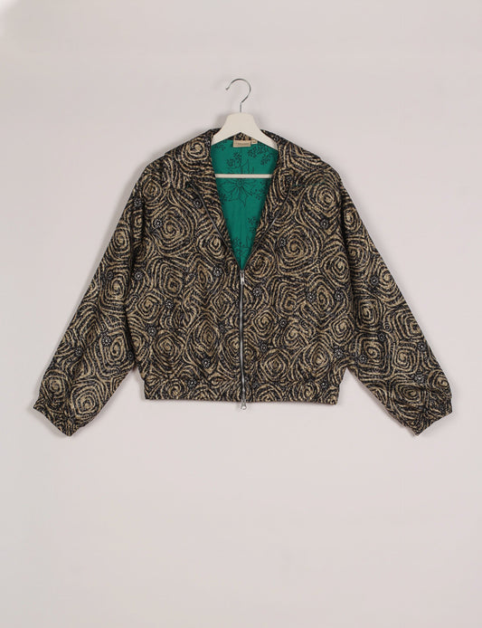 Stylish BOMBER JACKET, an upcycled clothing masterpiece with a cute cropped shape, elasticated details, and detachable metallic zipper. Contrast sari print lining adds a unique touch. Explore sustainable and eco-friendly fashion.