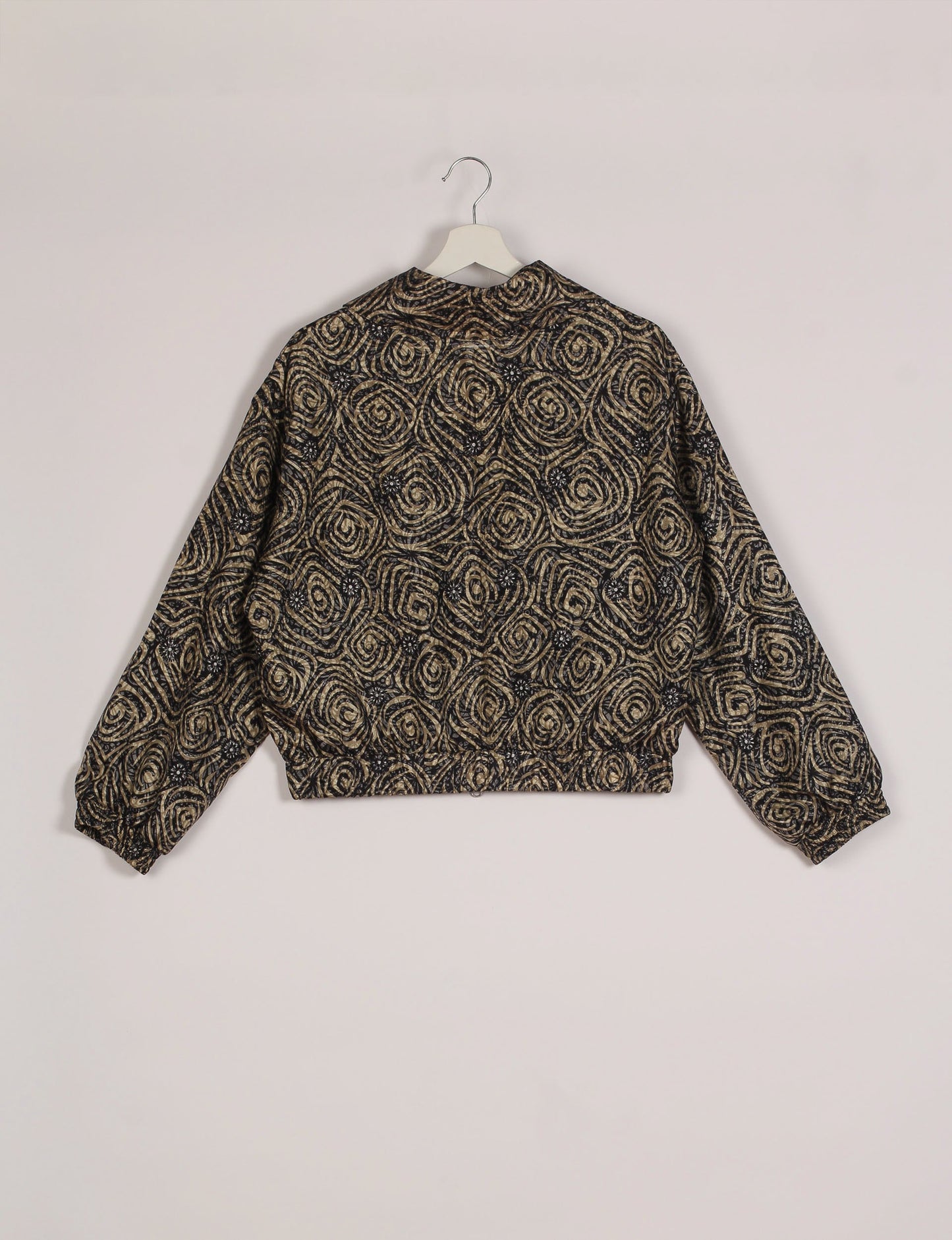 Stylish BOMBER JACKET, an upcycled clothing masterpiece with a cute cropped shape, elasticated details, and detachable metallic zipper. Contrast sari print lining adds a unique touch. Explore sustainable and eco-friendly fashion.