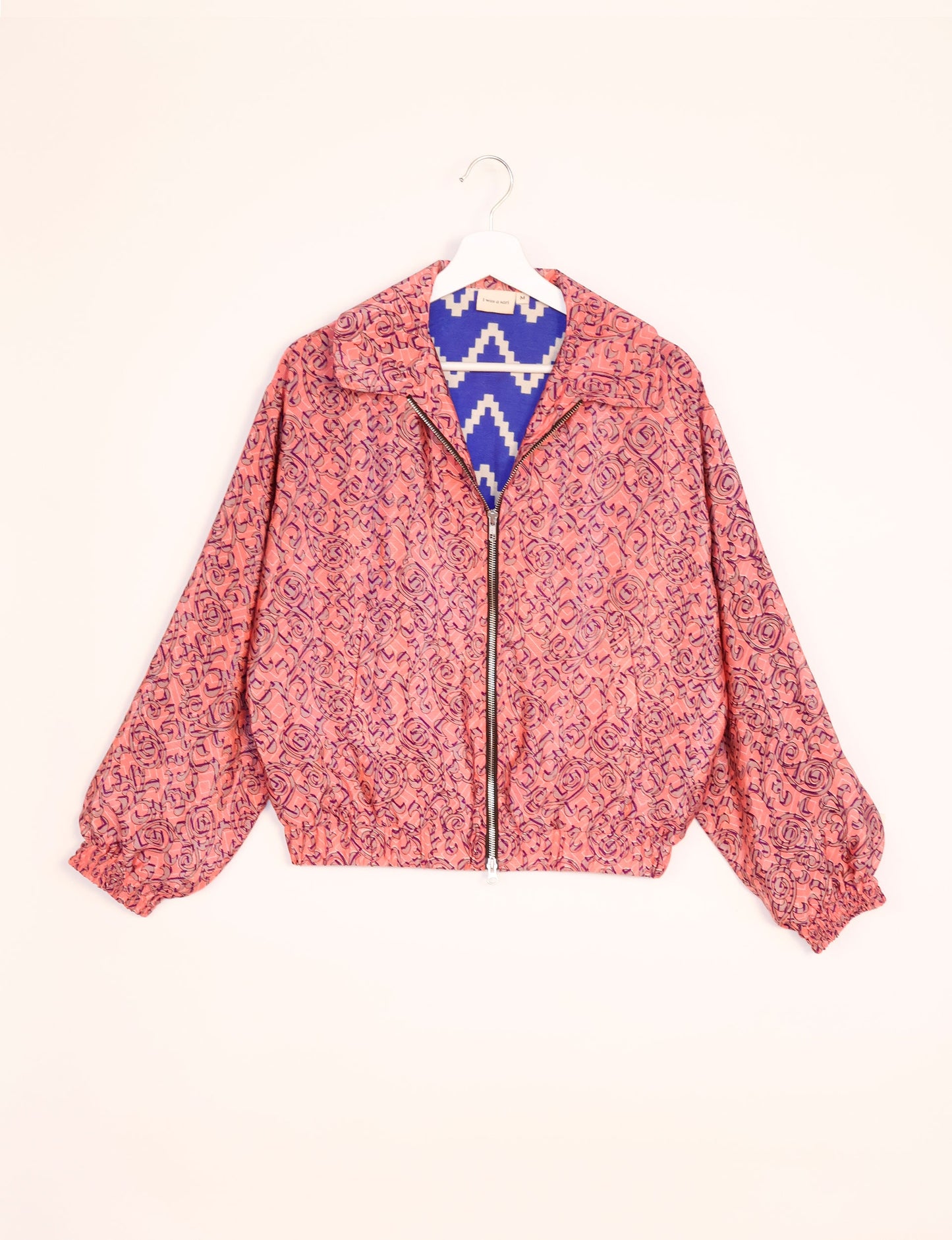 Stylish BOMBER JACKET, an upcycled clothing masterpiece with a cute cropped shape, elasticated details, and detachable metallic zipper. Contrast sari print lining adds a unique touch. Explore sustainable and eco-friendly fashion.