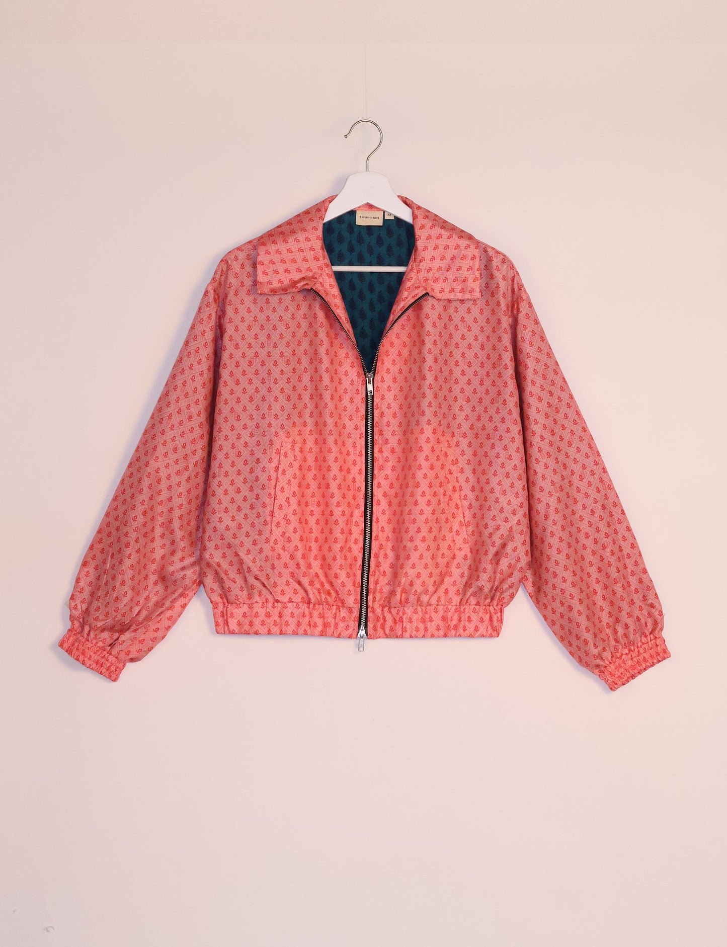 Stylish BOMBER JACKET, an upcycled clothing masterpiece with a cute cropped shape, elasticated details, and detachable metallic zipper. Contrast sari print lining adds a unique touch. Explore sustainable and eco-friendly fashion.