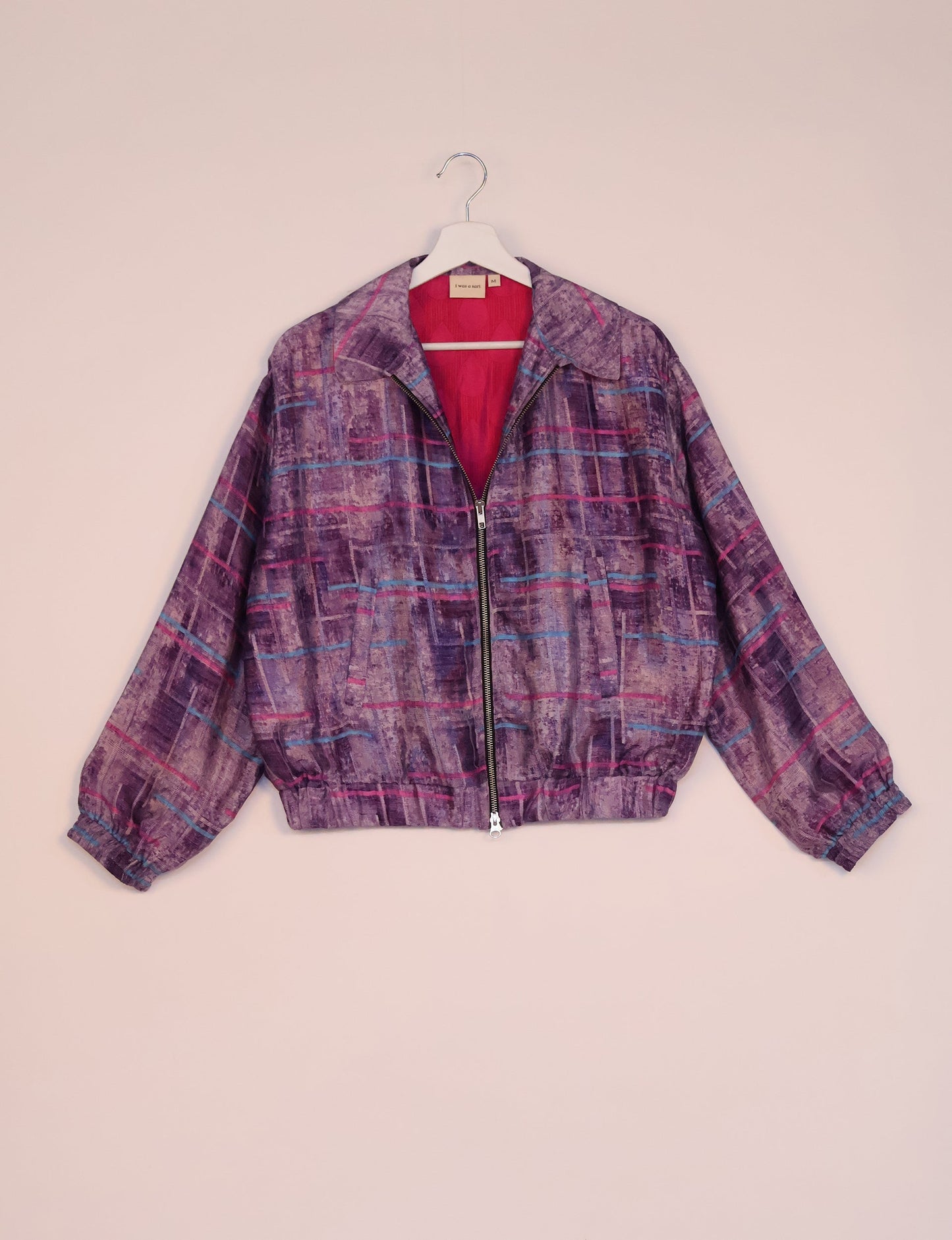 Stylish BOMBER JACKET, an upcycled clothing masterpiece with a cute cropped shape, elasticated details, and detachable metallic zipper. Contrast sari print lining adds a unique touch. Explore sustainable and eco-friendly fashion.