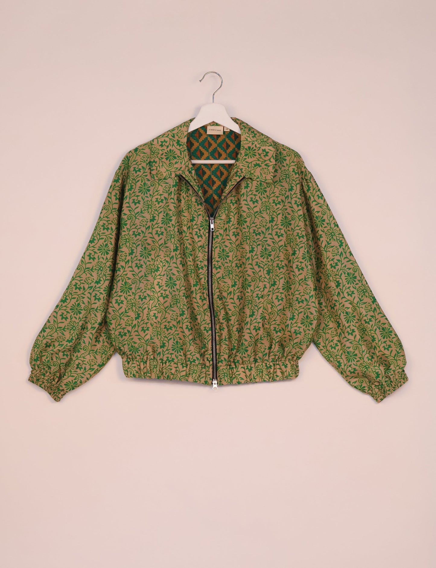 Stylish BOMBER JACKET, an upcycled clothing masterpiece with a cute cropped shape, elasticated details, and detachable metallic zipper. Contrast sari print lining adds a unique touch. Explore sustainable and eco-friendly fashion.