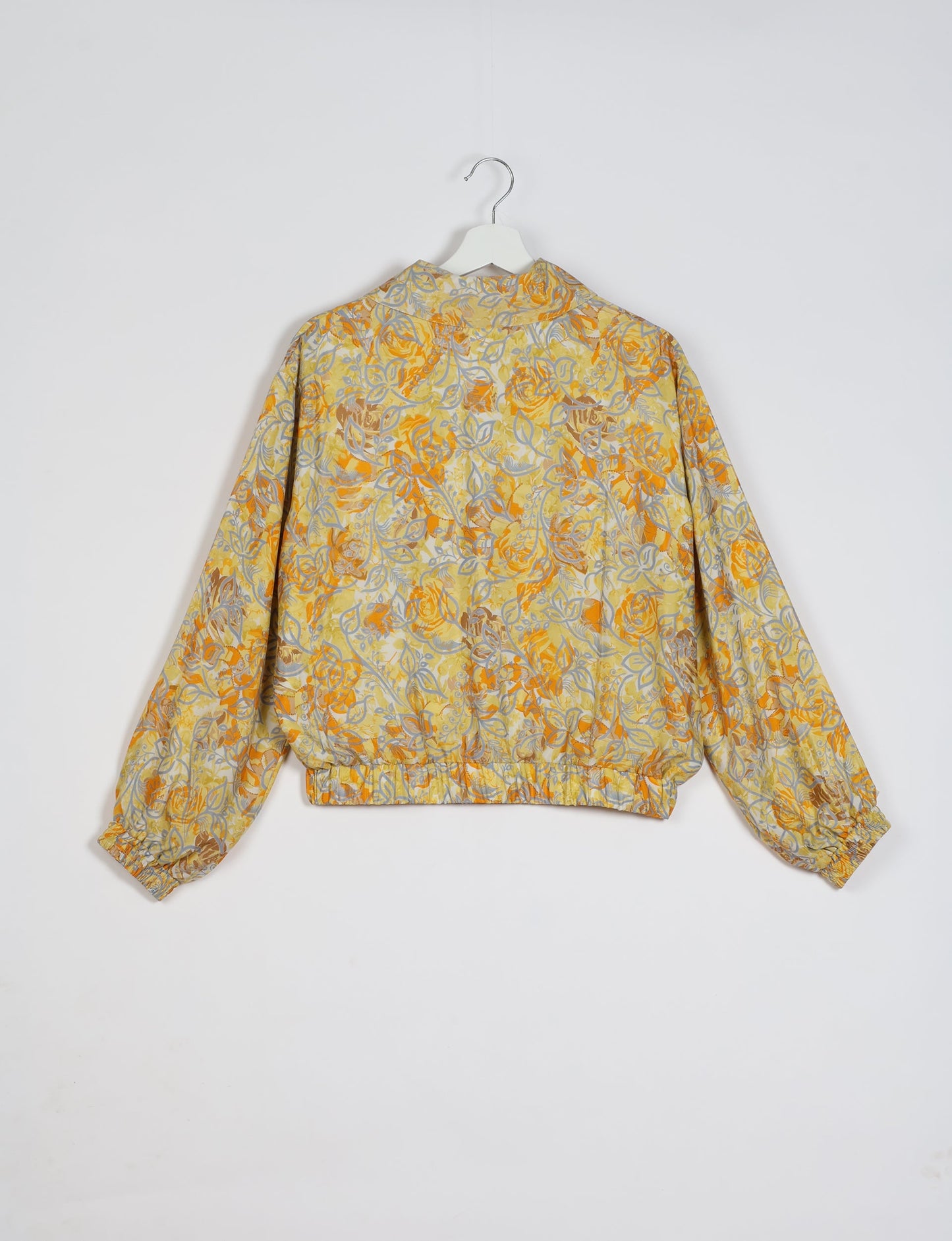 Stylish BOMBER JACKET, an upcycled clothing masterpiece with a cute cropped shape, elasticated details, and detachable metallic zipper. Contrast sari print lining adds a unique touch. Explore sustainable and eco-friendly fashion.