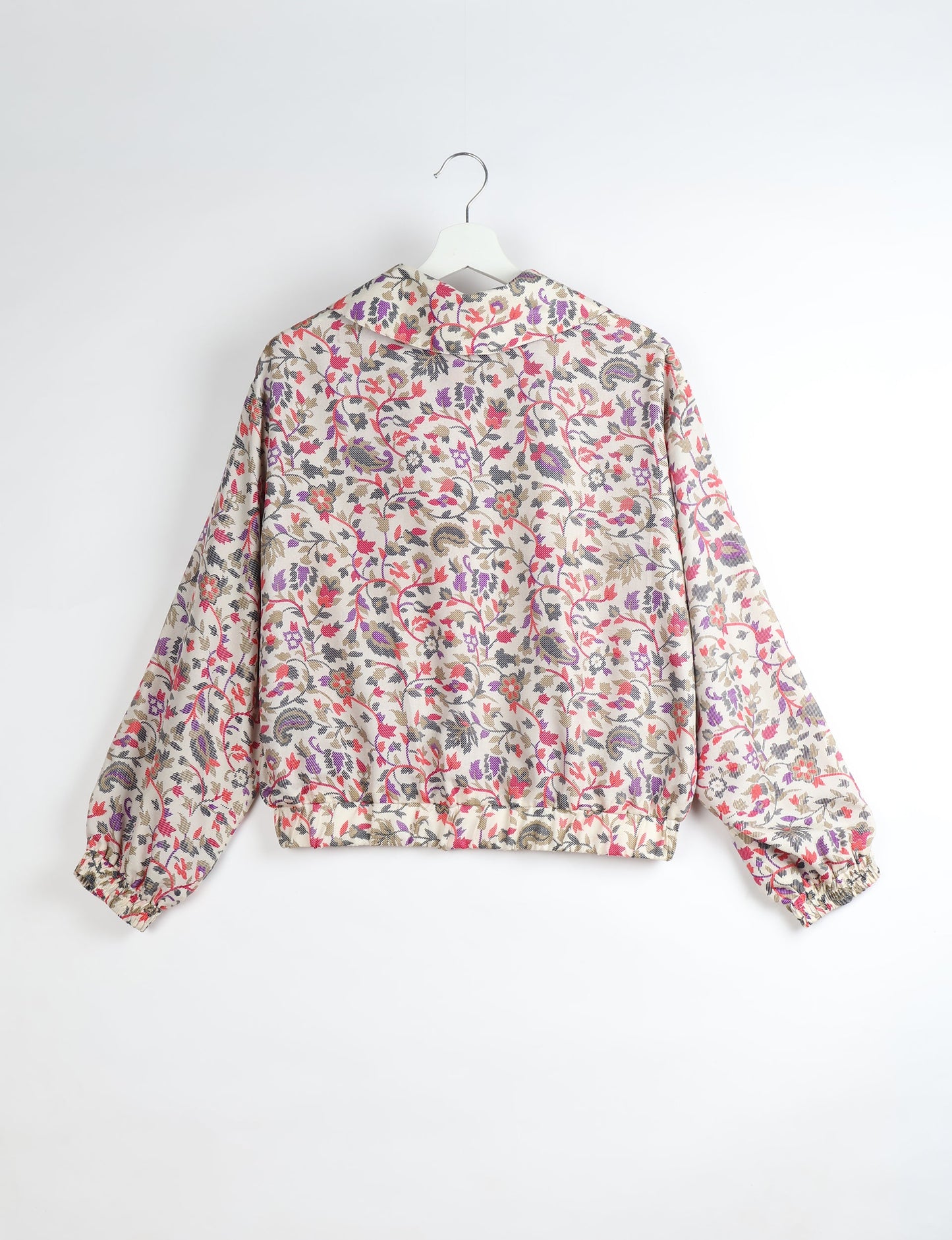 Upcycled Bomber Jacket made from recycled sari materials, featuring a cute cropped shape, elasticated hem and cuffs, and contrast sari print lining. Sustainable apparel promoting eco-friendly fashion and ethical clothing.