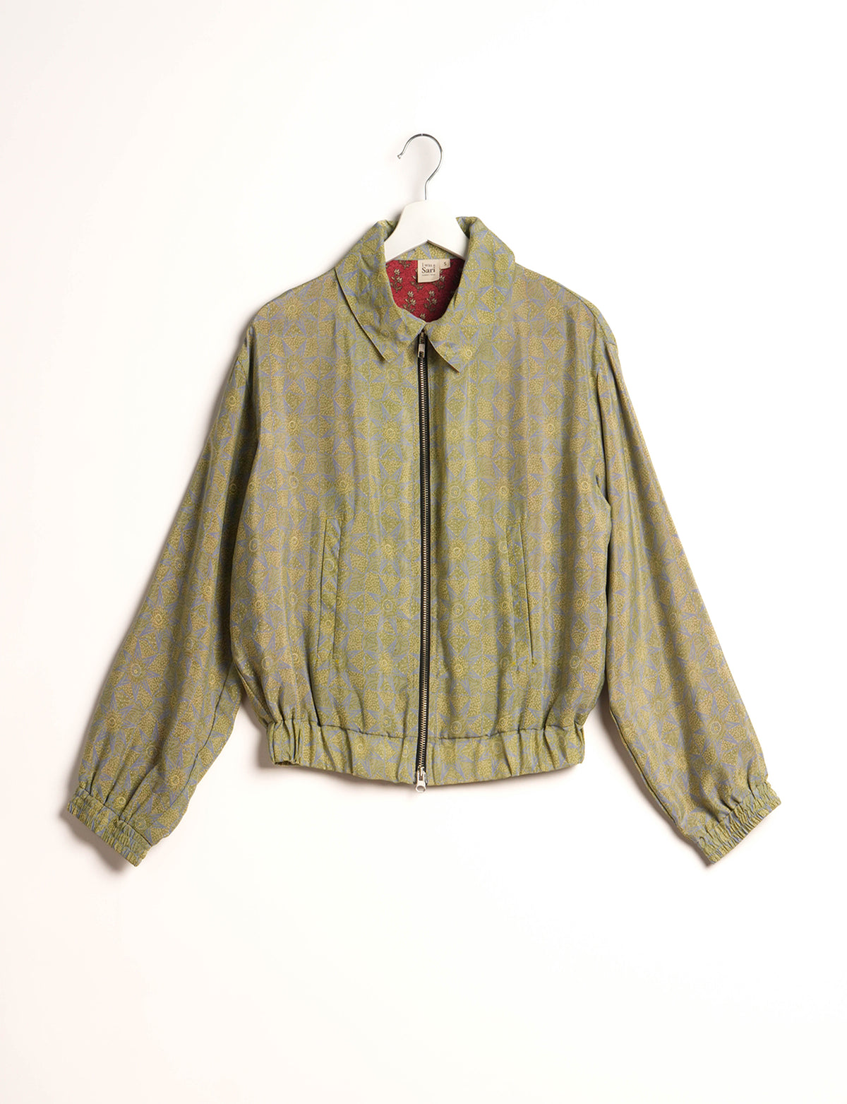 Stylish BOMBER JACKET, an upcycled clothing masterpiece with a cute cropped shape, elasticated details, and detachable metallic zipper. Contrast sari print lining adds a unique touch. Explore sustainable and eco-friendly fashion.