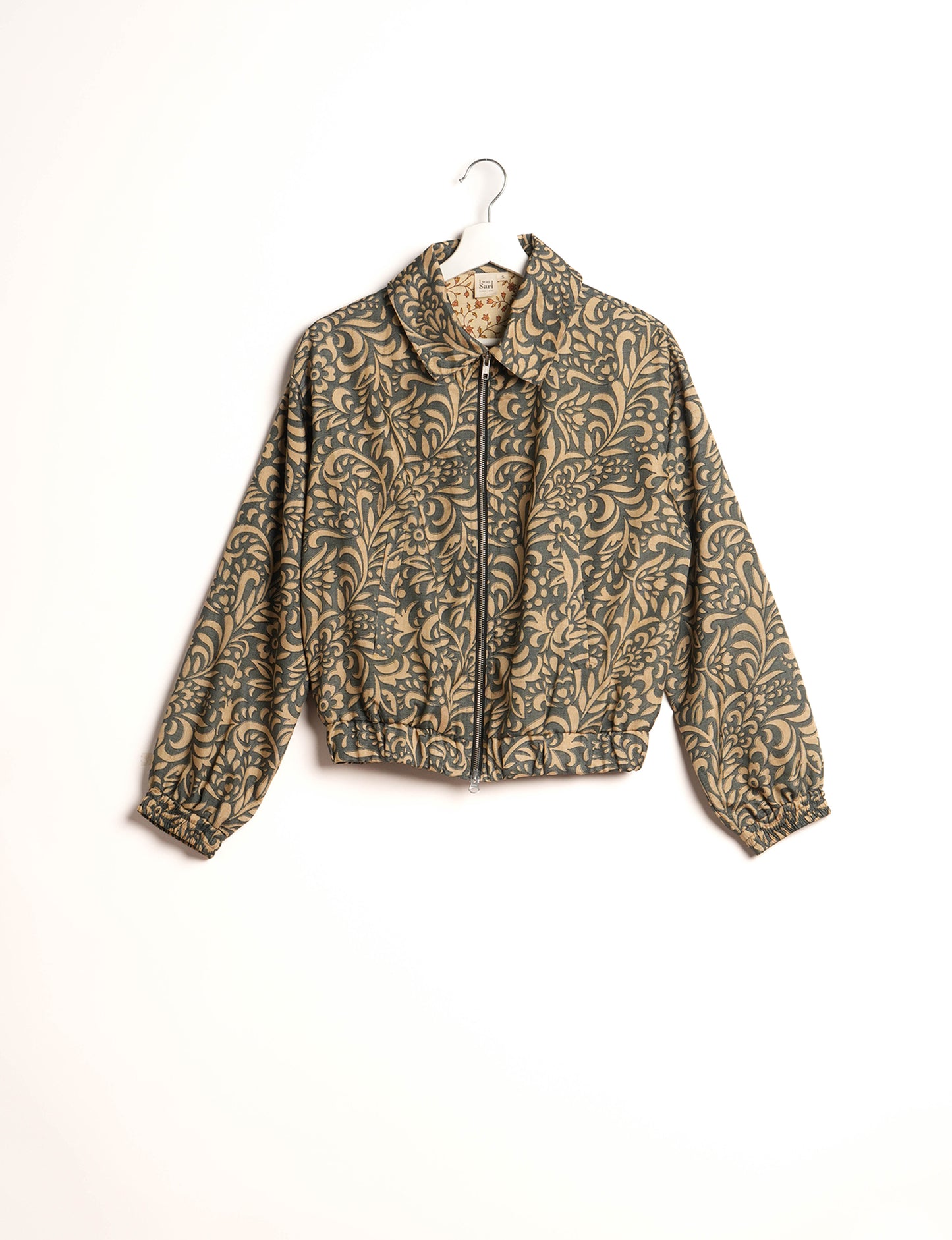 Stylish BOMBER JACKET, an upcycled clothing masterpiece with a cute cropped shape, elasticated details, and detachable metallic zipper. Contrast sari print lining adds a unique touch. Explore sustainable and eco-friendly fashion.