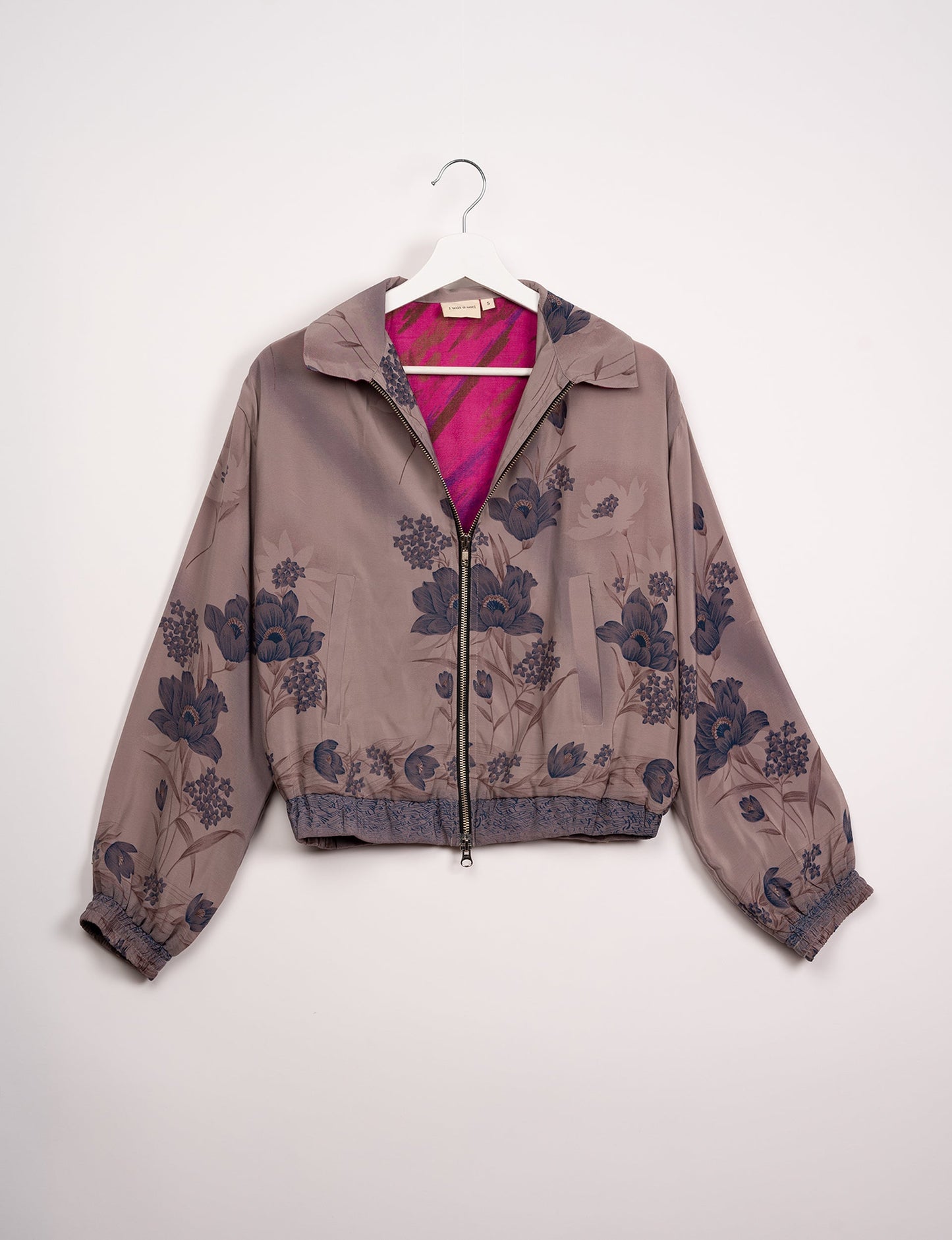 Stylish BOMBER JACKET, an upcycled clothing masterpiece with a cute cropped shape, elasticated details, and detachable metallic zipper. Contrast sari print lining adds a unique touch. Explore sustainable and eco-friendly fashion.