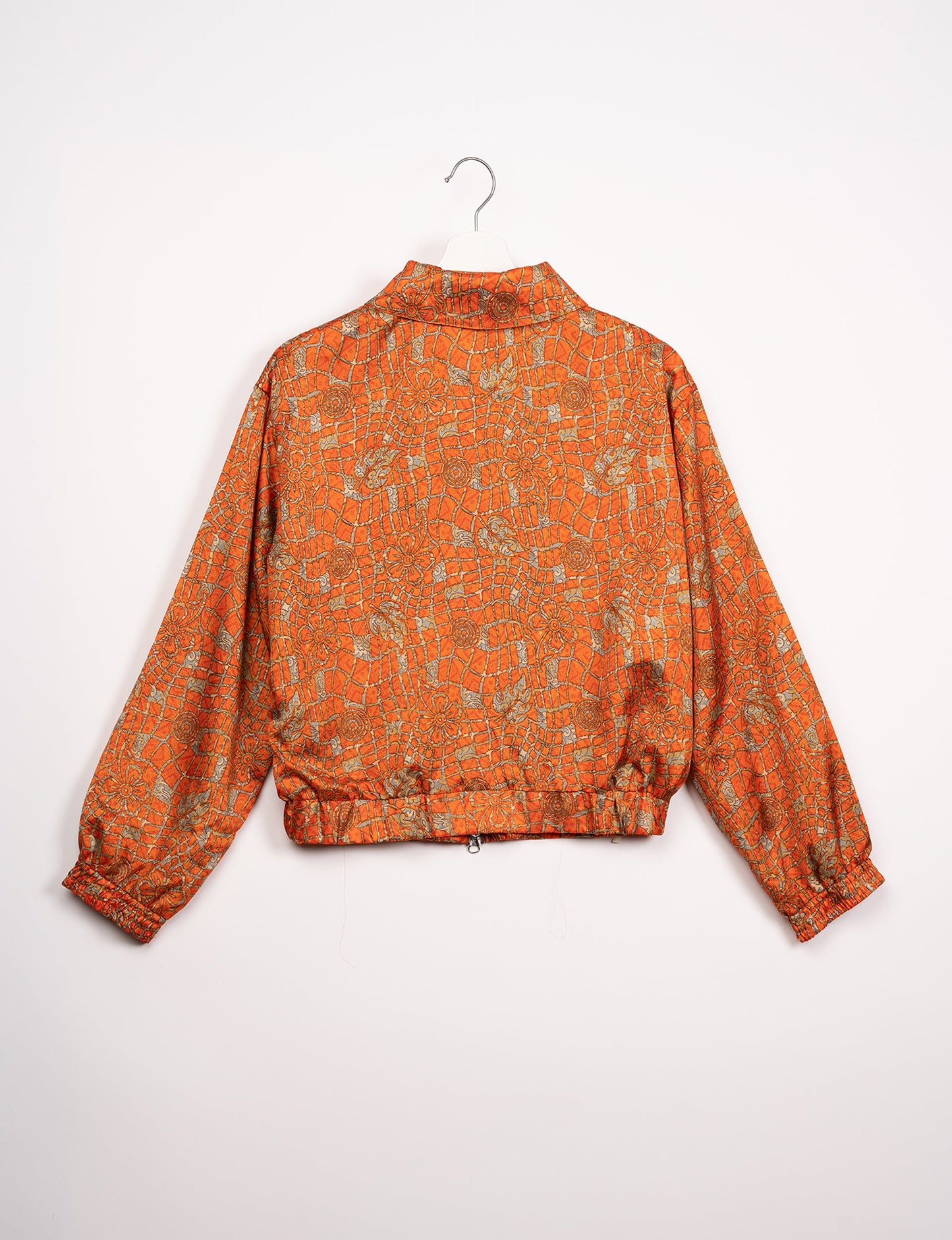 Stylish BOMBER JACKET, an upcycled clothing masterpiece with a cute cropped shape, elasticated details, and detachable metallic zipper. Contrast sari print lining adds a unique touch. Explore sustainable and eco-friendly fashion.