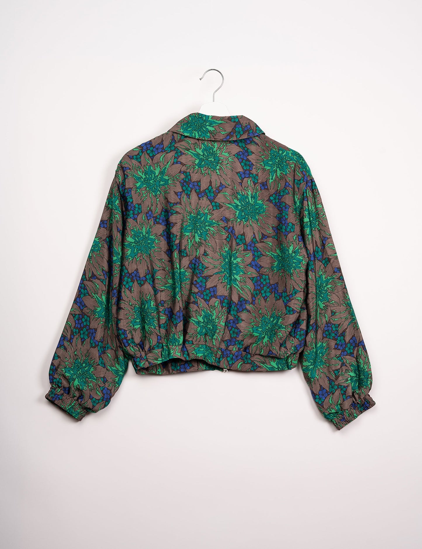 Stylish BOMBER JACKET, an upcycled clothing masterpiece with a cute cropped shape, elasticated details, and detachable metallic zipper. Contrast sari print lining adds a unique touch. Explore sustainable and eco-friendly fashion.