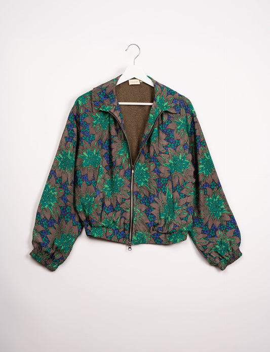 Stylish BOMBER JACKET, an upcycled clothing masterpiece with a cute cropped shape, elasticated details, and detachable metallic zipper. Contrast sari print lining adds a unique touch. Explore sustainable and eco-friendly fashion.