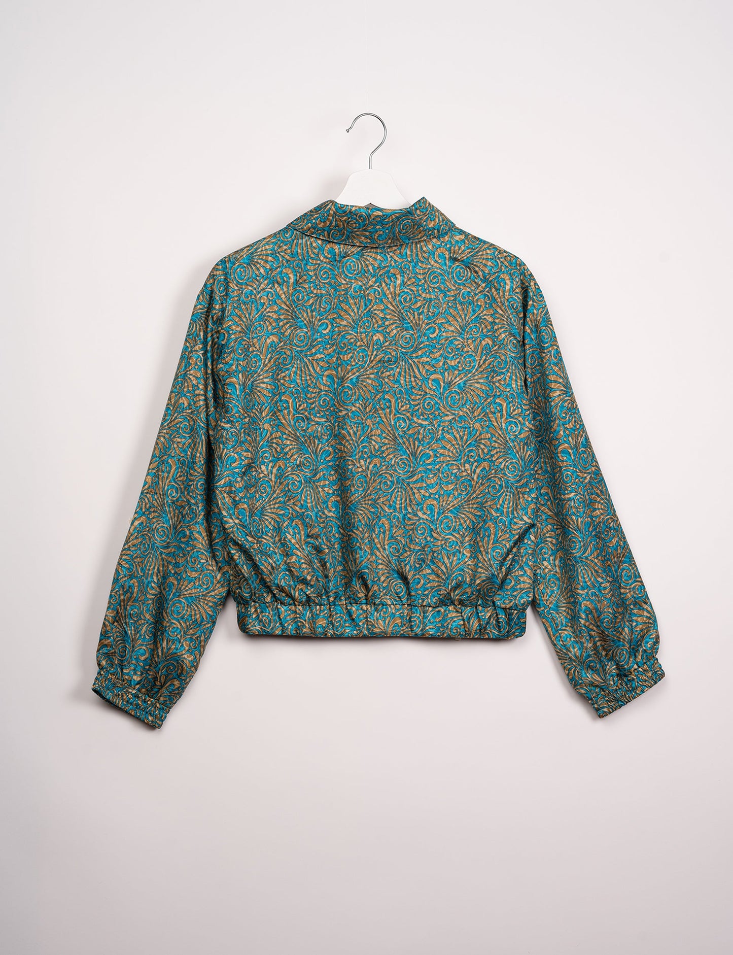 Stylish BOMBER JACKET, an upcycled clothing masterpiece with a cute cropped shape, elasticated details, and detachable metallic zipper. Contrast sari print lining adds a unique touch. Explore sustainable and eco-friendly fashion.