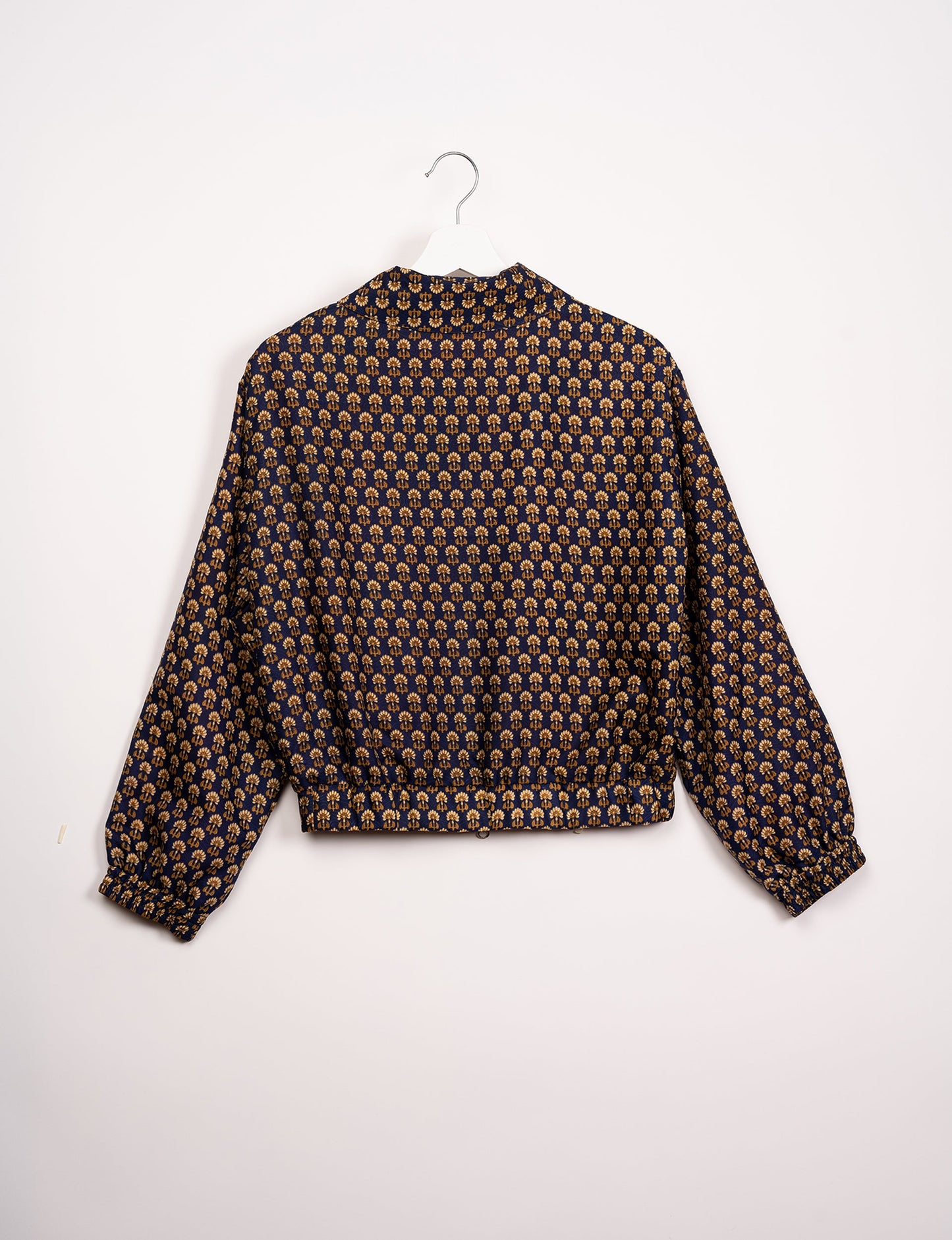 Stylish BOMBER JACKET, an upcycled clothing masterpiece with a cute cropped shape, elasticated details, and detachable metallic zipper. Contrast sari print lining adds a unique touch. Explore sustainable and eco-friendly fashion.