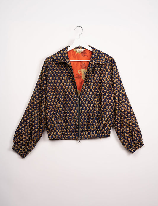 Stylish BOMBER JACKET, an upcycled clothing masterpiece with a cute cropped shape, elasticated details, and detachable metallic zipper. Contrast sari print lining adds a unique touch. Explore sustainable and eco-friendly fashion.