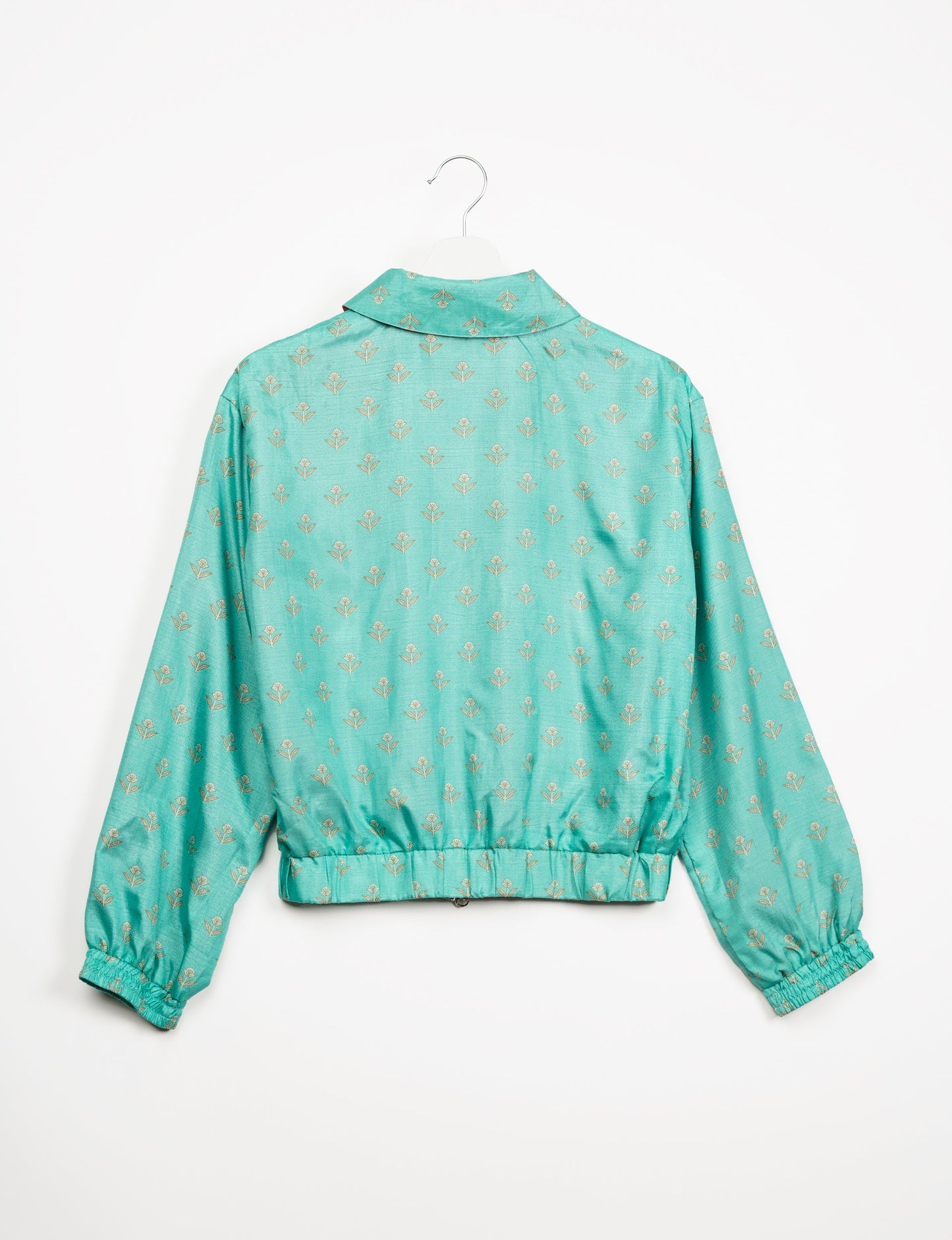 Stylish BOMBER JACKET, an upcycled clothing masterpiece with a cute cropped shape, elasticated details, and detachable metallic zipper. Contrast sari print lining adds a unique touch. Explore sustainable and eco-friendly fashion.