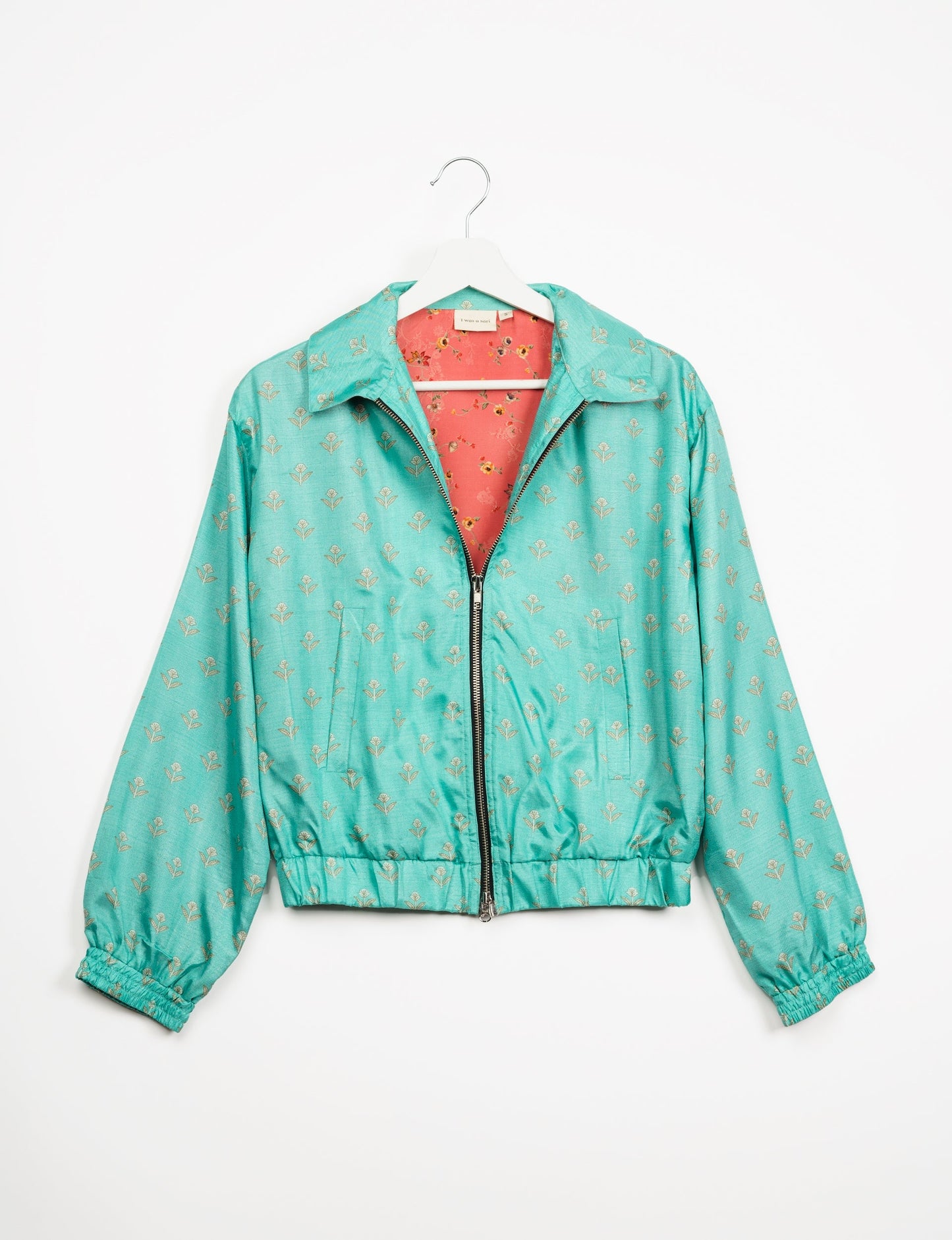 Stylish BOMBER JACKET, an upcycled clothing masterpiece with a cute cropped shape, elasticated details, and detachable metallic zipper. Contrast sari print lining adds a unique touch. Explore sustainable and eco-friendly fashion.