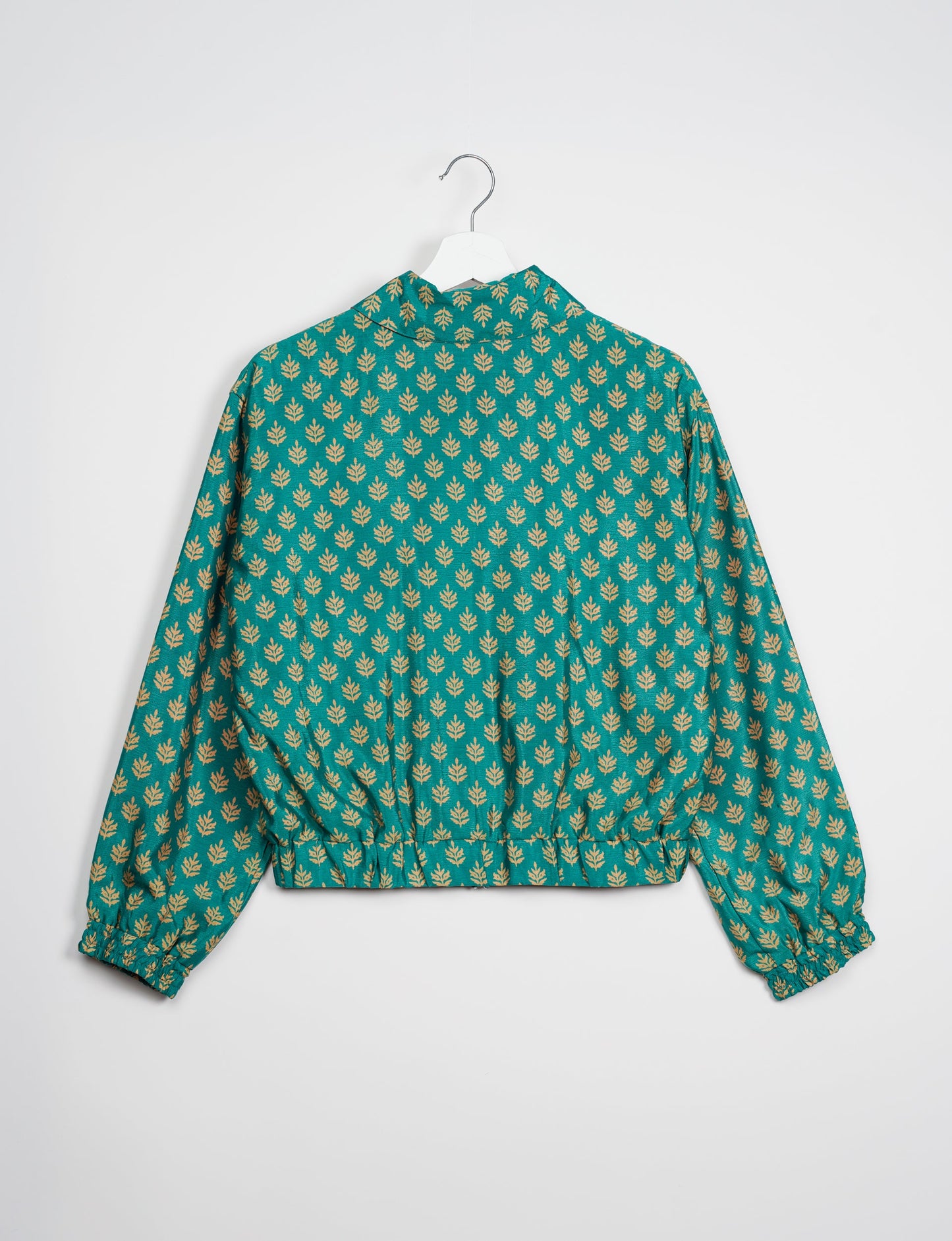 Stylish BOMBER JACKET, an upcycled clothing masterpiece with a cute cropped shape, elasticated details, and detachable metallic zipper. Contrast sari print lining adds a unique touch. Explore sustainable and eco-friendly fashion.