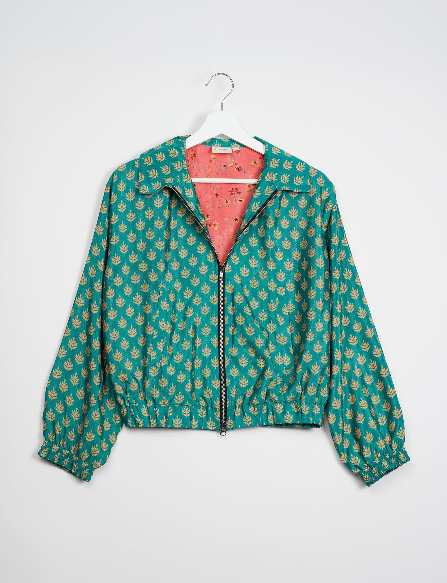 Stylish BOMBER JACKET, an upcycled clothing masterpiece with a cute cropped shape, elasticated details, and detachable metallic zipper. Contrast sari print lining adds a unique touch. Explore sustainable and eco-friendly fashion.