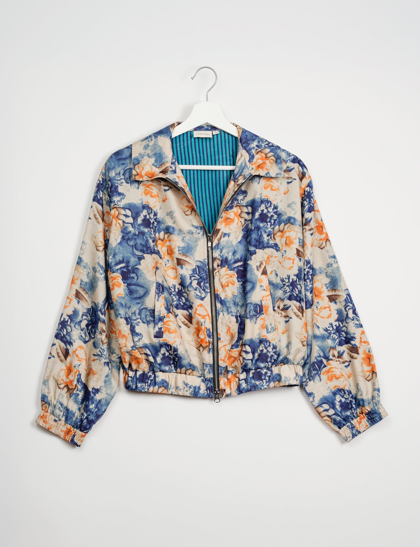 Stylish BOMBER JACKET, an upcycled clothing masterpiece with a cute cropped shape, elasticated details, and detachable metallic zipper. Contrast sari print lining adds a unique touch. Explore sustainable and eco-friendly fashion.