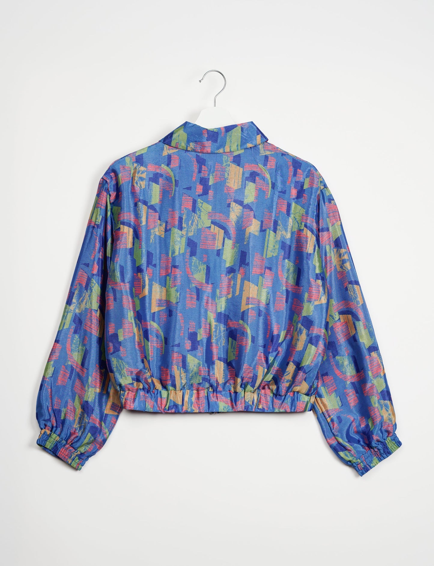 Stylish BOMBER JACKET, an upcycled clothing masterpiece with a cute cropped shape, elasticated details, and detachable metallic zipper. Contrast sari print lining adds a unique touch. Explore sustainable and eco-friendly fashion.