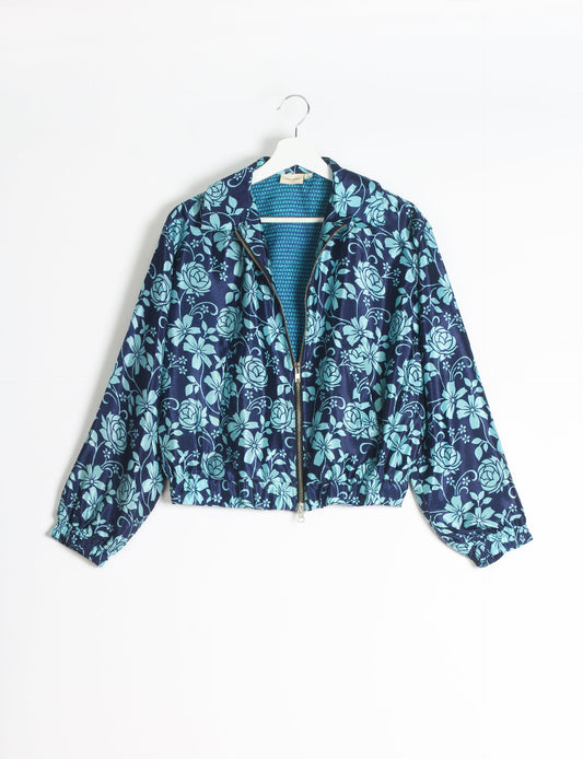 Stylish BOMBER JACKET, an upcycled clothing masterpiece with a cute cropped shape, elasticated details, and detachable metallic zipper. Contrast sari print lining adds a unique touch. Explore sustainable and eco-friendly fashion.