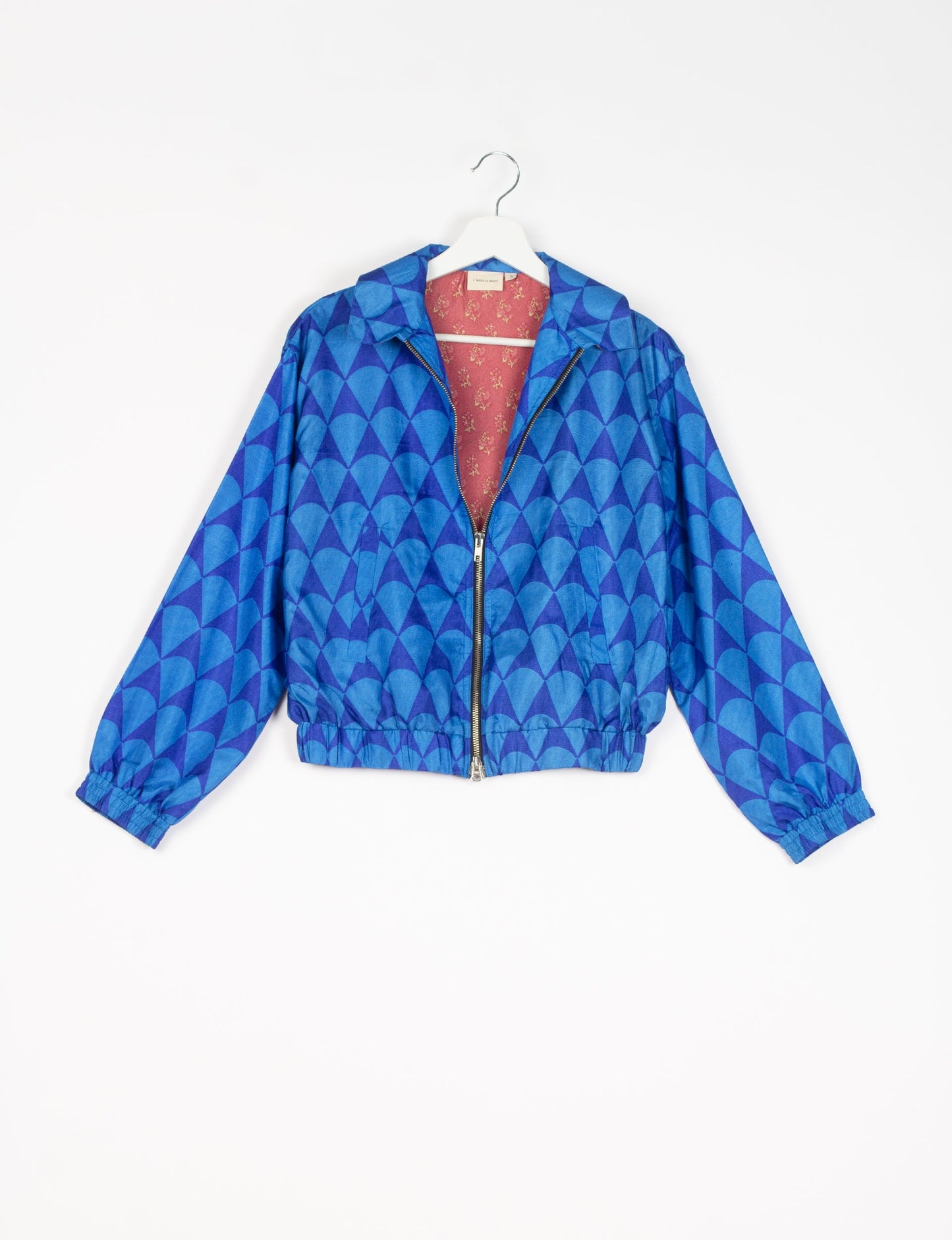 Stylish BOMBER JACKET, an upcycled clothing masterpiece with a cute cropped shape, elasticated details, and detachable metallic zipper. Contrast sari print lining adds a unique touch. Explore sustainable and eco-friendly fashion.