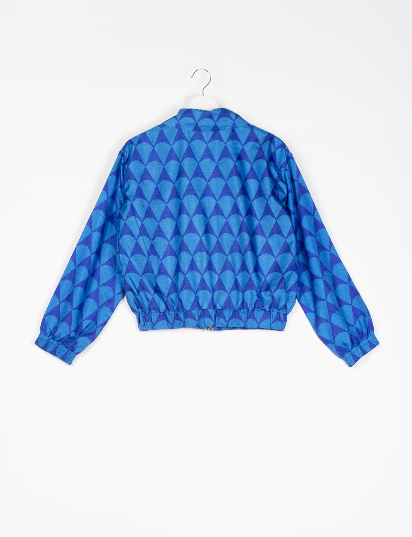 Stylish BOMBER JACKET, an upcycled clothing masterpiece with a cute cropped shape, elasticated details, and detachable metallic zipper. Contrast sari print lining adds a unique touch. Explore sustainable and eco-friendly fashion.