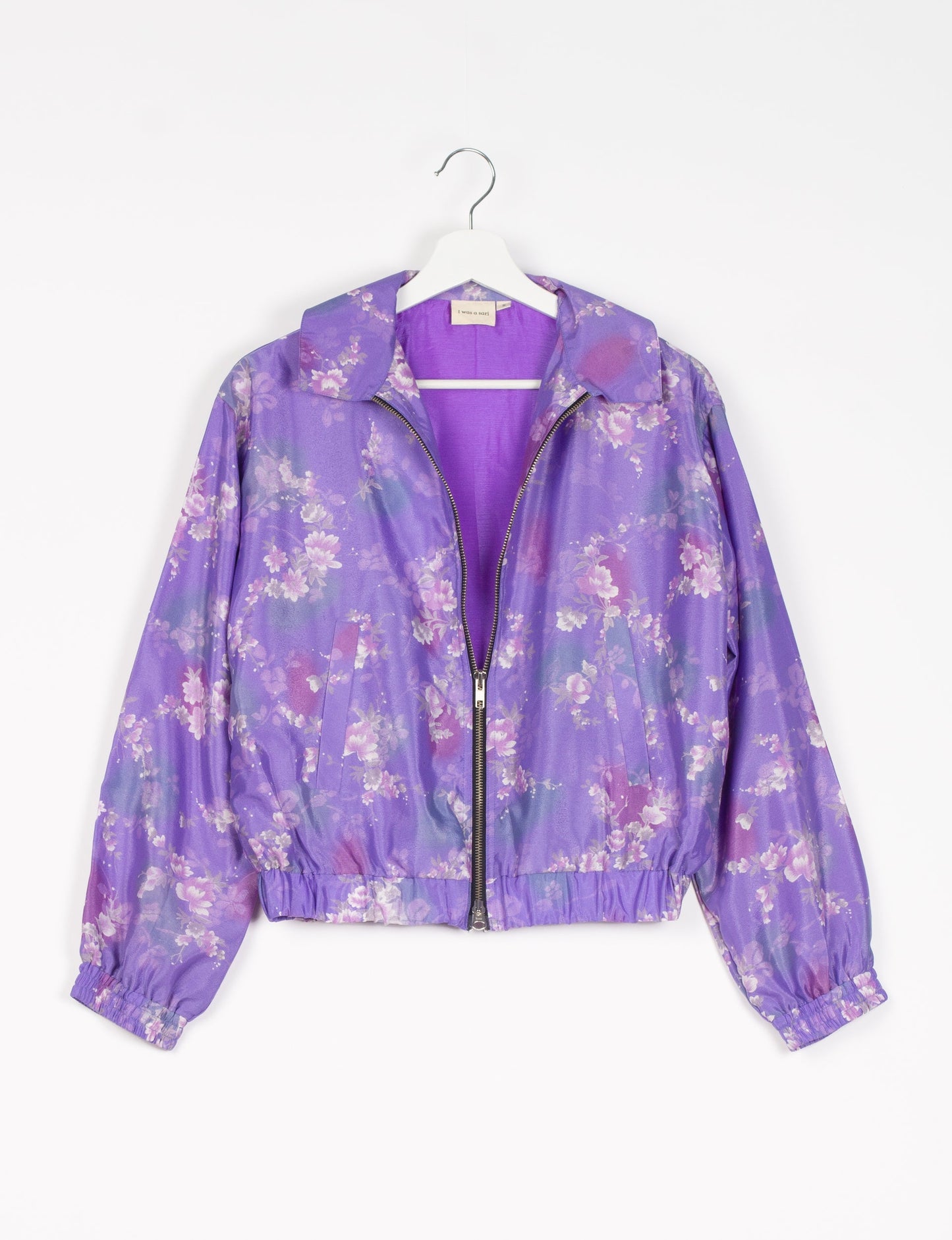 Stylish BOMBER JACKET, an upcycled clothing masterpiece with a cute cropped shape, elasticated details, and detachable metallic zipper. Contrast sari print lining adds a unique touch. Explore sustainable and eco-friendly fashion.