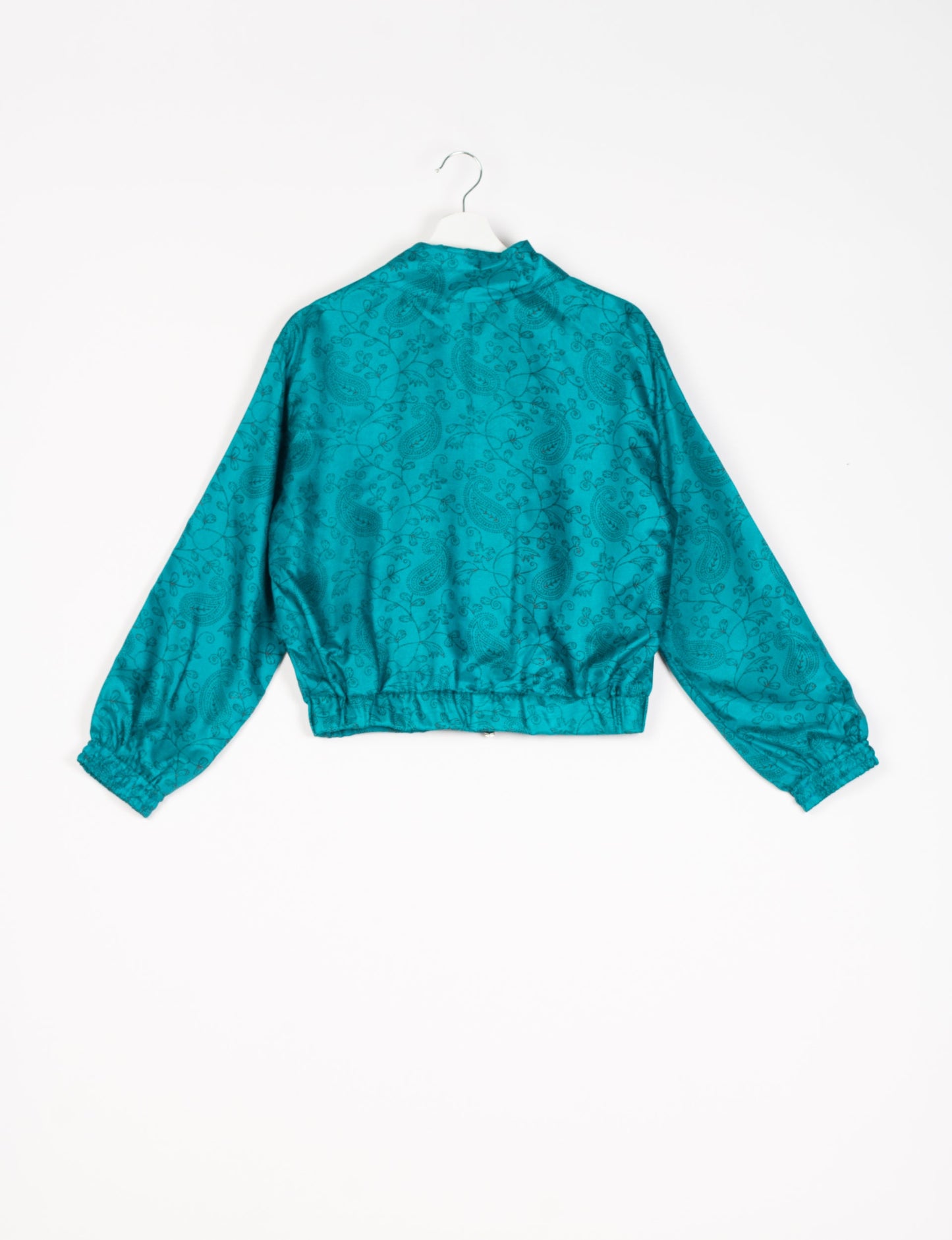 Stylish BOMBER JACKET, an upcycled clothing masterpiece with a cute cropped shape, elasticated details, and detachable metallic zipper. Contrast sari print lining adds a unique touch. Explore sustainable and eco-friendly fashion.