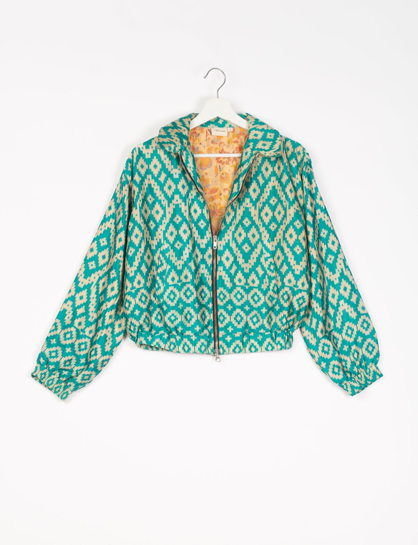 Stylish BOMBER JACKET, an upcycled clothing masterpiece with a cute cropped shape, elasticated details, and detachable metallic zipper. Contrast sari print lining adds a unique touch. Explore sustainable and eco-friendly fashion.