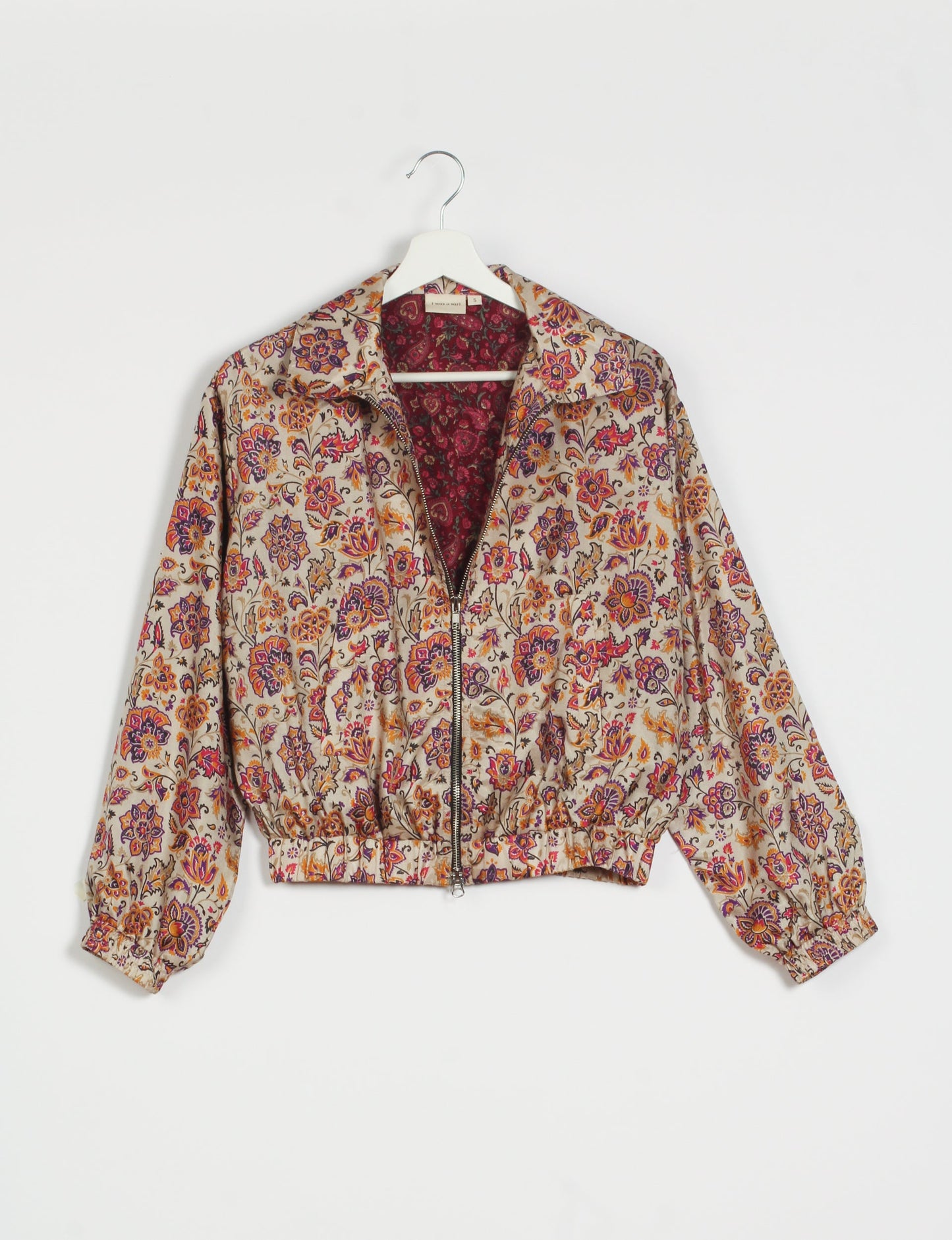 Stylish BOMBER JACKET, an upcycled clothing masterpiece with a cute cropped shape, elasticated details, and detachable metallic zipper. Contrast sari print lining adds a unique touch. Explore sustainable and eco-friendly fashion.