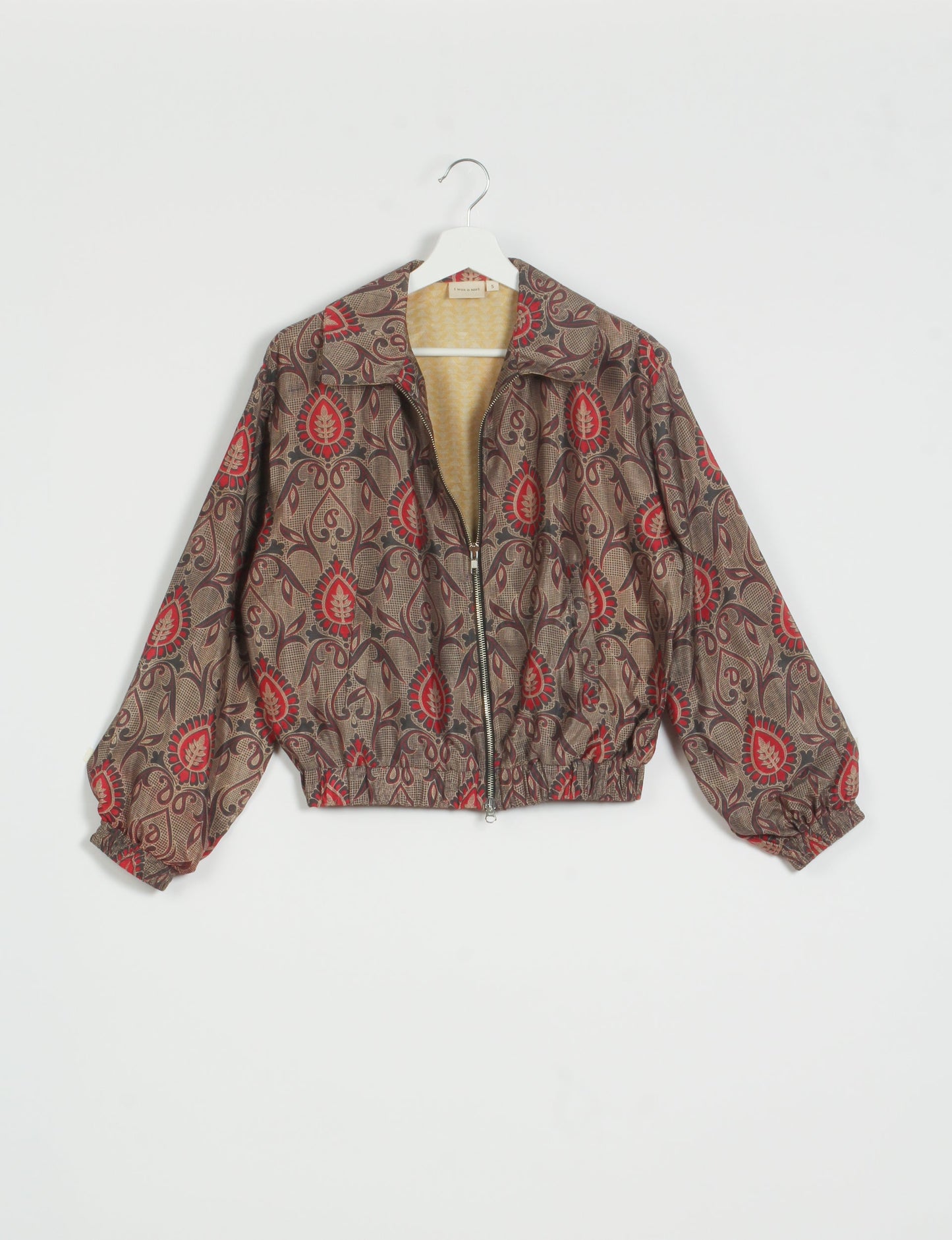 Stylish BOMBER JACKET, an upcycled clothing masterpiece with a cute cropped shape, elasticated details, and detachable metallic zipper. Contrast sari print lining adds a unique touch. Explore sustainable and eco-friendly fashion.