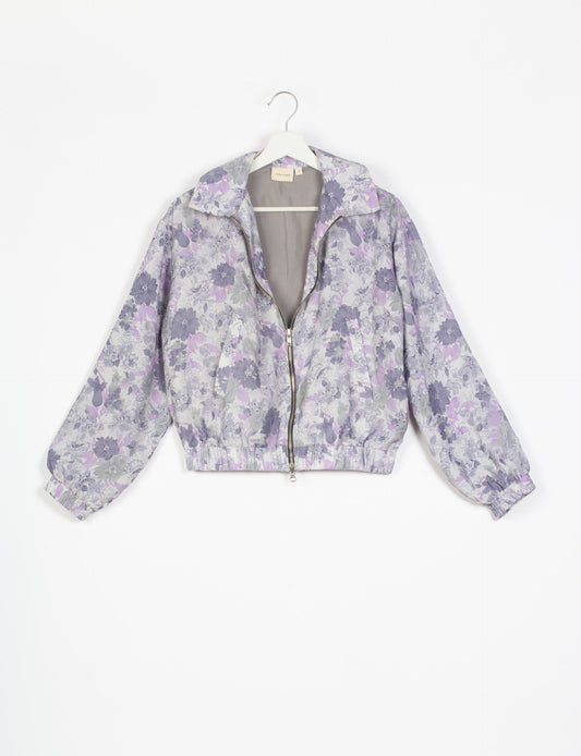 Stylish BOMBER JACKET, an upcycled clothing masterpiece with a cute cropped shape, elasticated details, and detachable metallic zipper. Contrast sari print lining adds a unique touch. Explore sustainable and eco-friendly fashion.